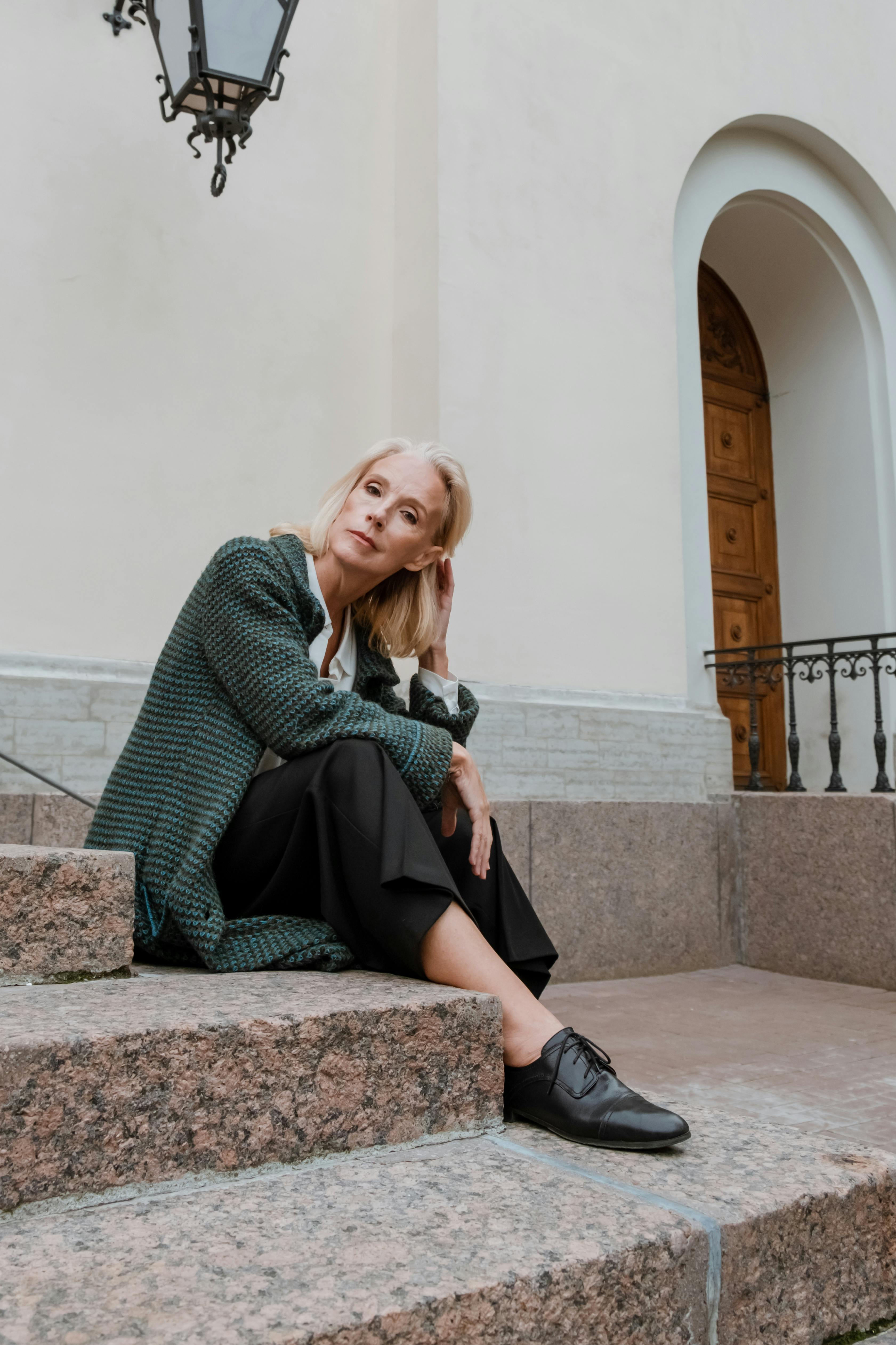 A woman sitting on steps | Source: Pexels