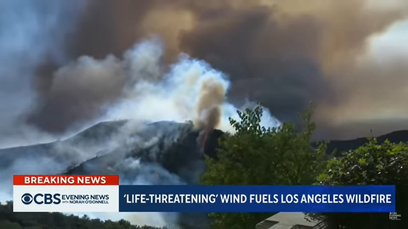 Mountaintop pictured on fire on January 7, 2025, in Los Angeles, California. | Source: YouTube/CBSEveningNews