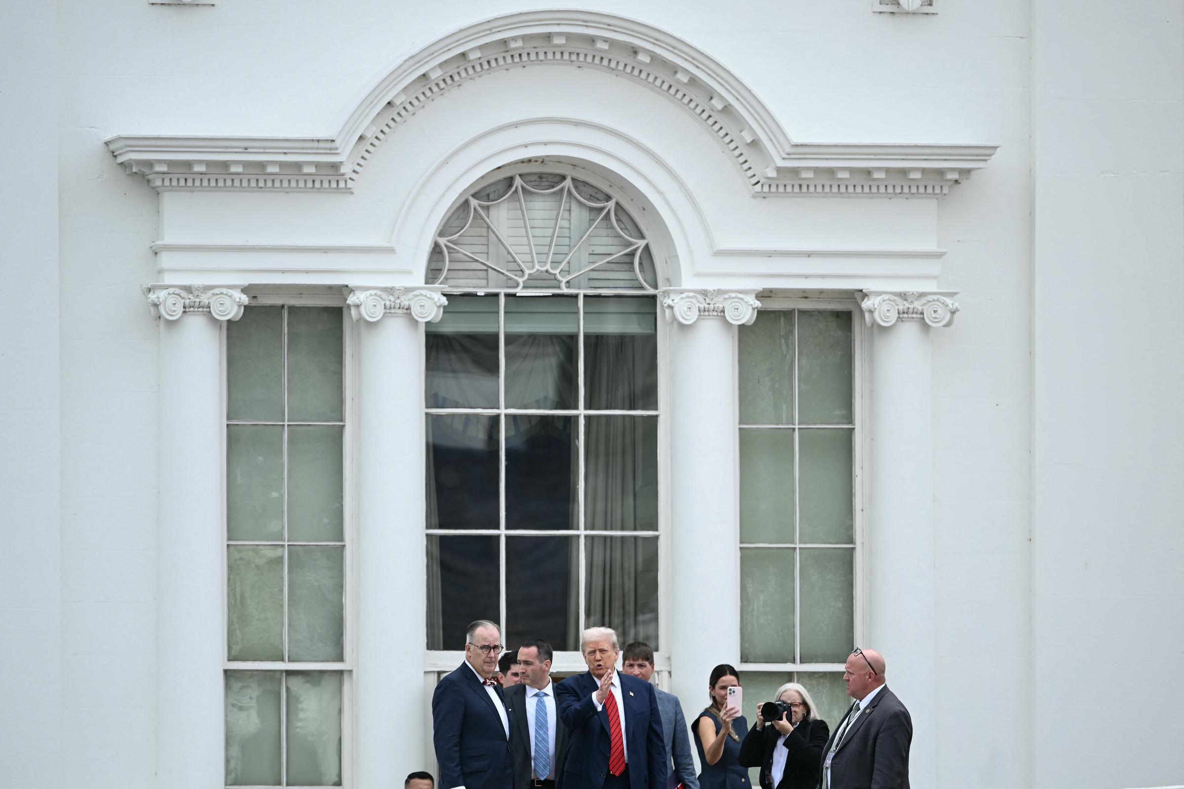 Standing alongside aides on the West Wing roof of the White House, President Donald Trump appeared engaged in an animated discussion during his unexpected rooftop tour.