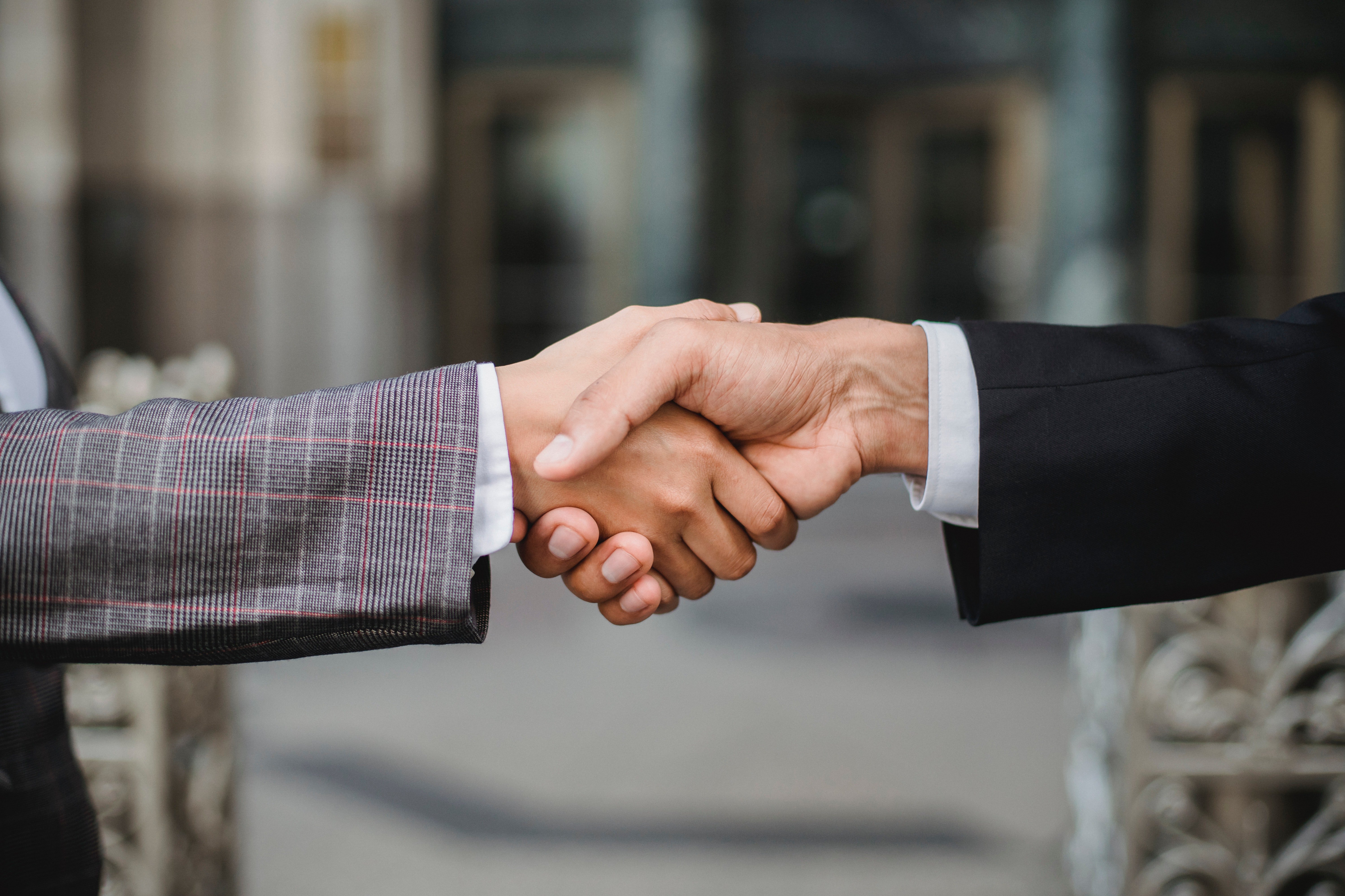 OP shakes hands with his late wife's boyfriend | Photo: Pexels