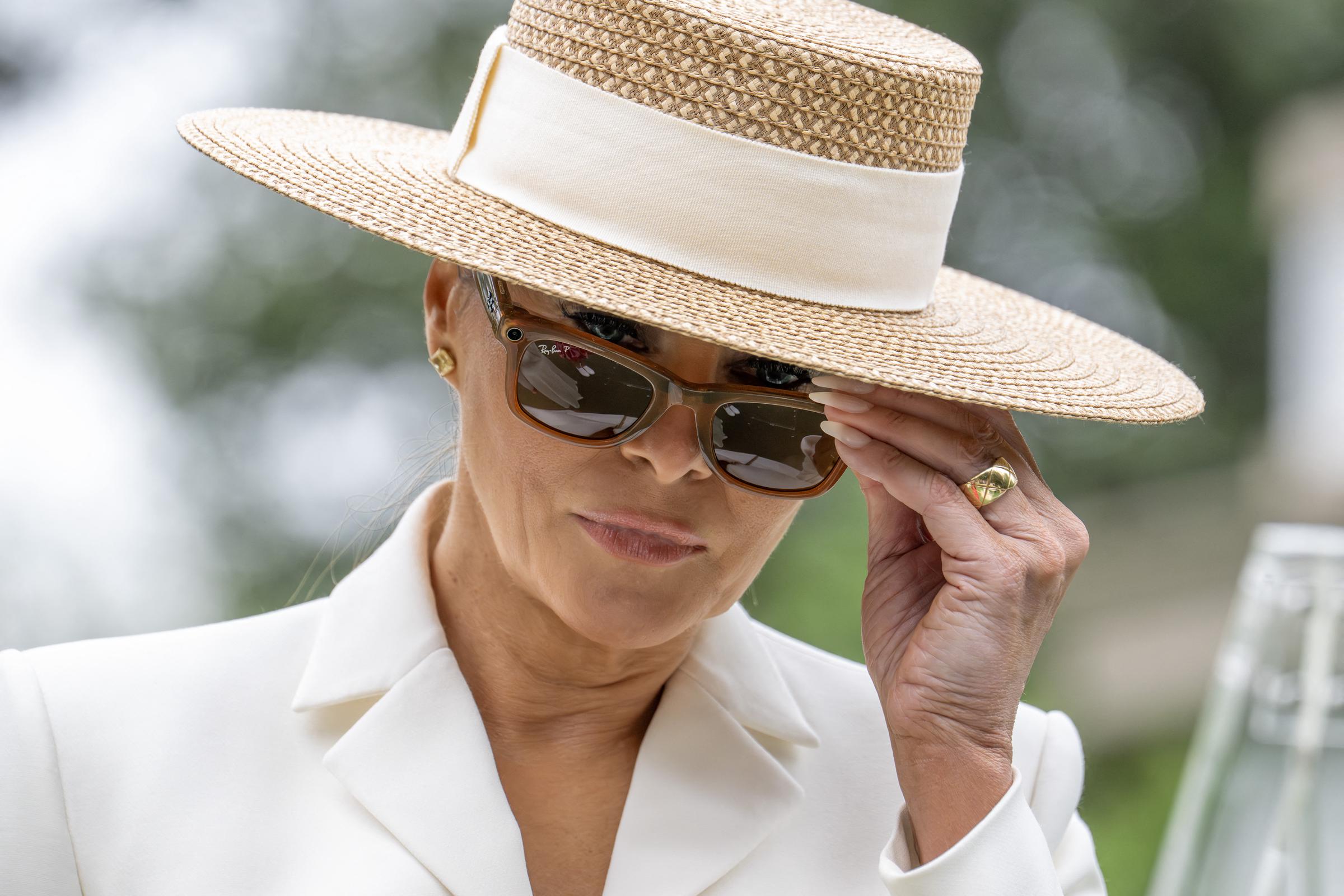 Melania Trump tries on Meta RayBan glasses during a youth activity with Britain's Queen Camilla on the White House tennis court area in Washington, DC, on April 28, 2026. | Source: Getty Images