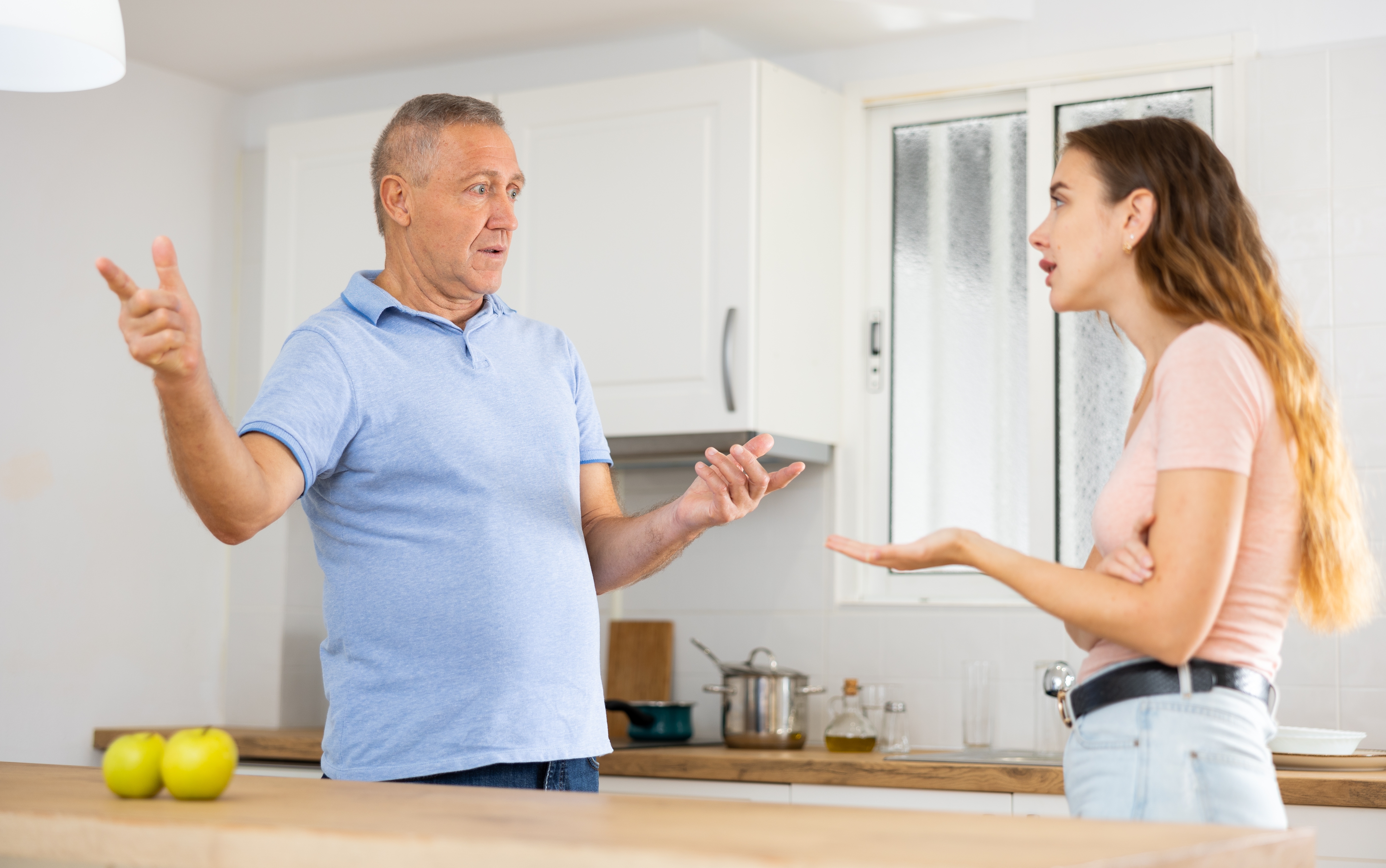 An older man and a younger woman fighting | Source: Shutterstock