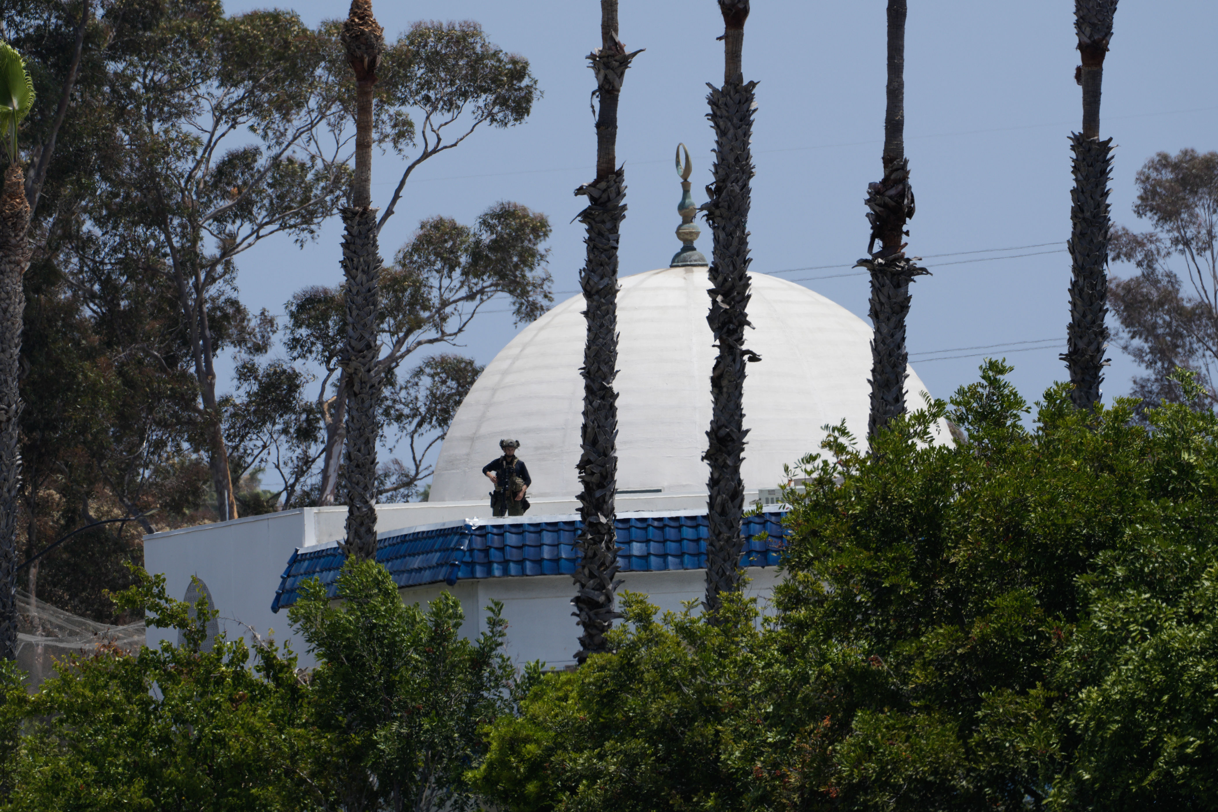 An officer stands guard on the roof of the Islamic Center of San Diego on May 18, 2026 | Source: Getty Images