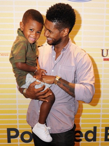 Usher (R) and his son, Usher Raymond V, attend Usher's New Look Foundation - World Leadership Conference & Awards 2011 - Day 2 at Cobb Galleria on July 21, 2011, in Atlanta, Georgia. | Source: Getty Images.