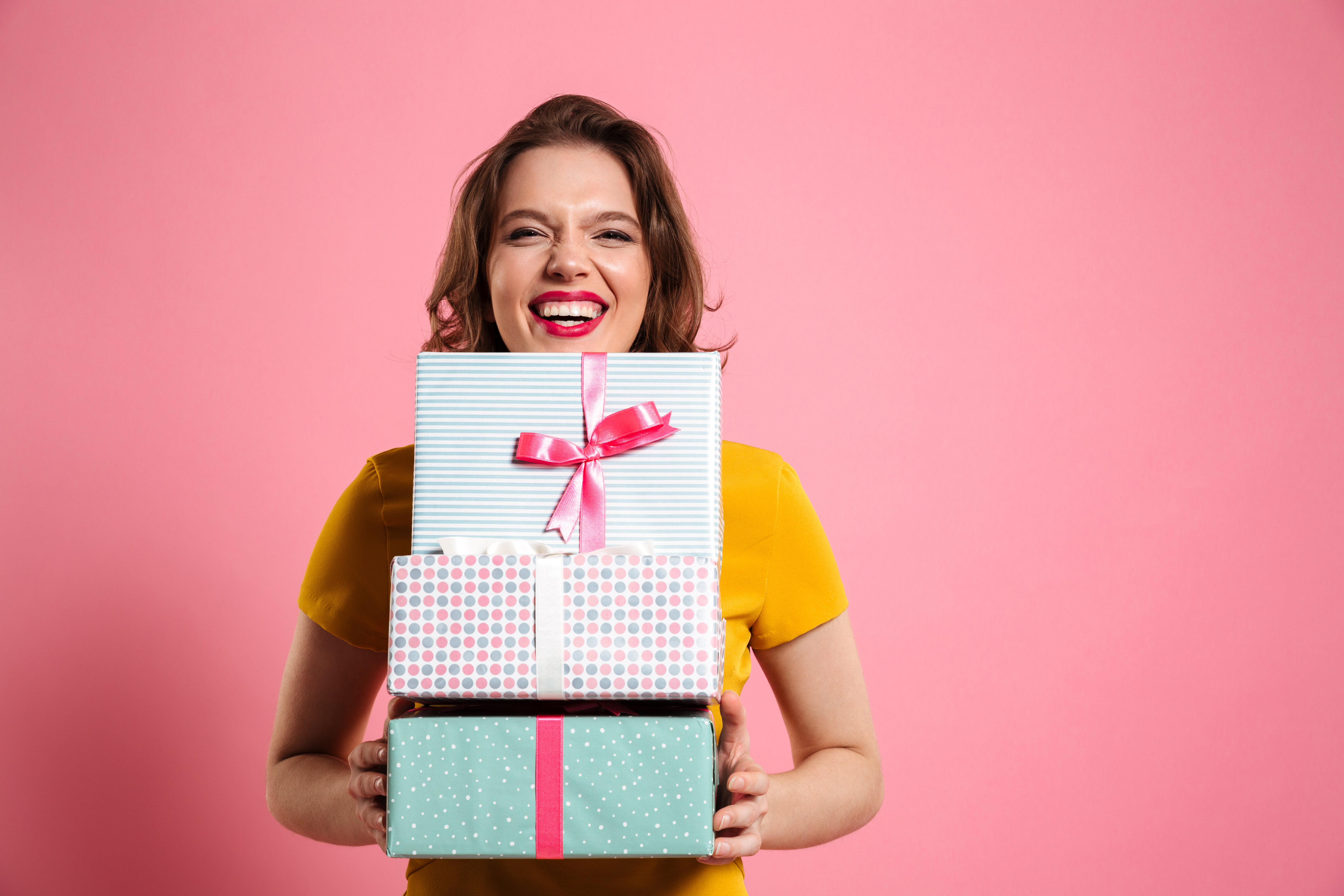 A woman holding gifts | Source: Shutterstock