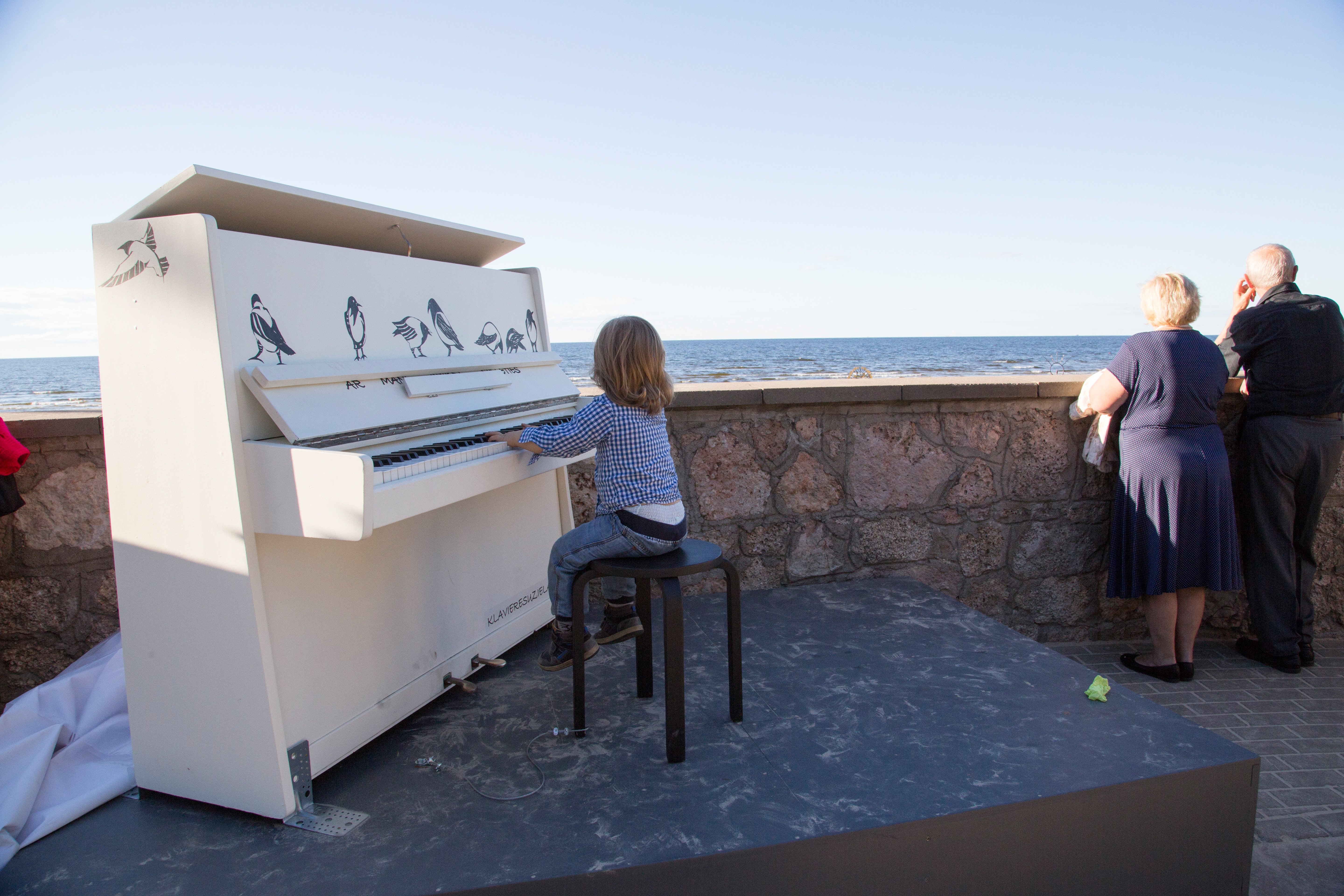 A boy plays piano at the Latvian Baltic Sea beach Jurmala. With a panoramic view of the sea,|Photo: Getty Images
