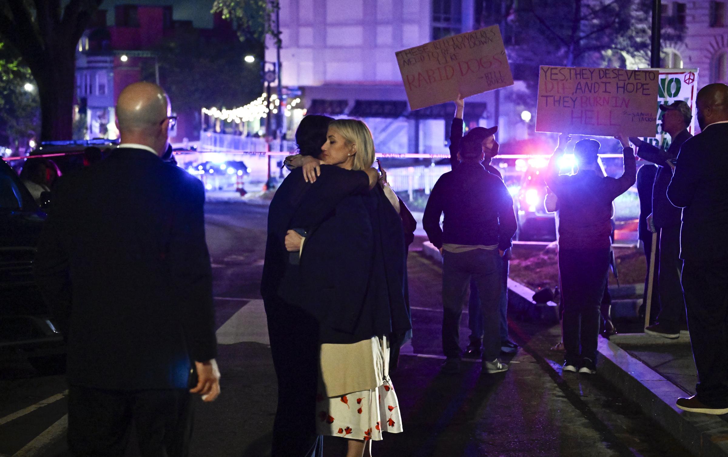 Attendees embrace outside the Washington Hilton after shots were heard during the White House Correspondents' Dinner on April 25, 2026, in Washington, DC | Source: Getty Images