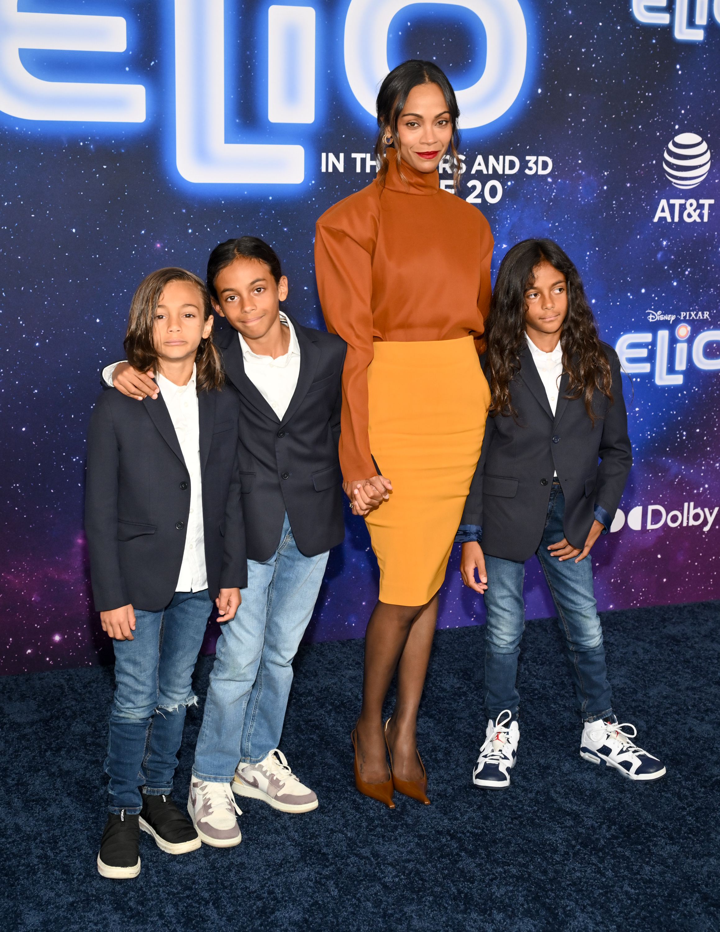 Zoe Saldaña and her sons express the love between them as they were photographed in a sweet moment where one of the boys hold hands with her at the "Elio" premiere