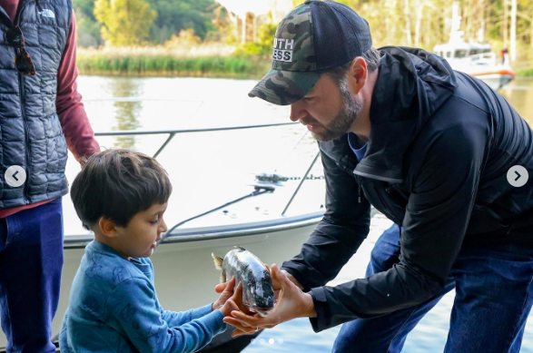 JD Vance helping his son Vivek Vance hold a fish during their fishing trip, posted on October 3, 2024. | Source: Instagram/jdvance