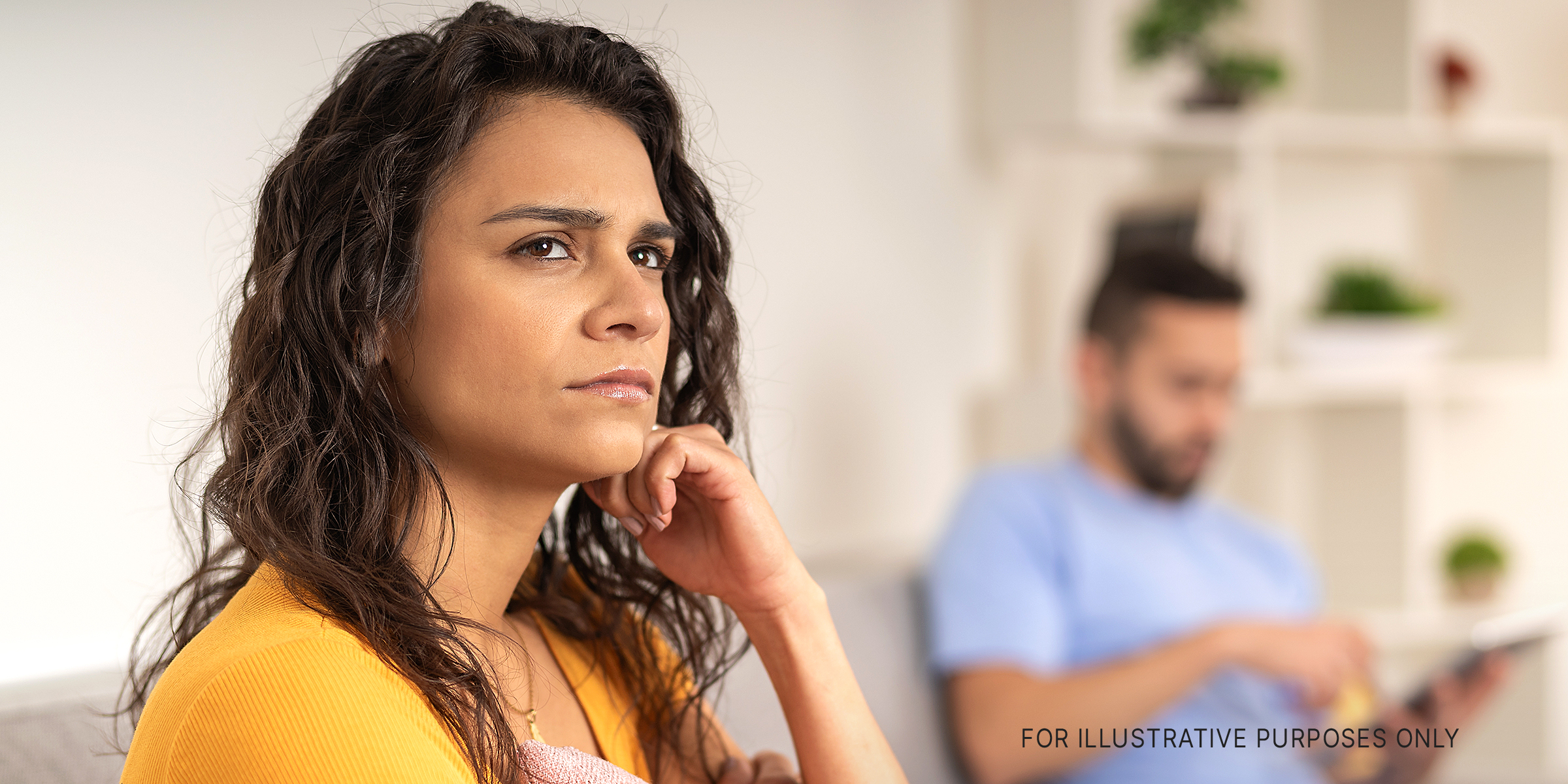 A worried woman looking away from her husband | Source: Shutterstock