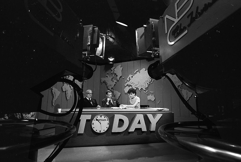 View of the desk on the set of the 'Today' show during filming, New York, New York, 1966. Pictured are, from left, author Harry Golden (1902 - 1981), and broadcast journalists Hugh Downs and Barbara Walters. | Source: Getty Images