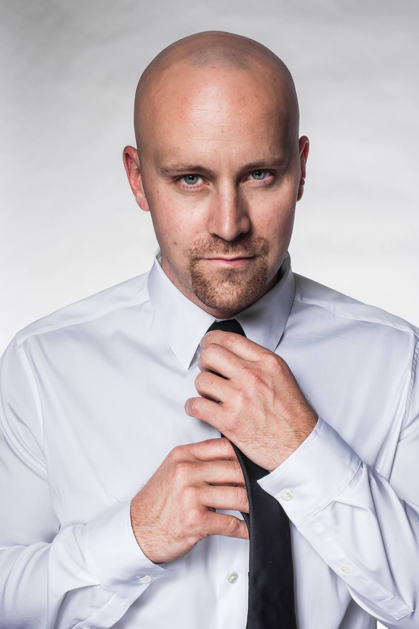 Joe McCann posing for the camera while adjusting his tie, posted on November 22, 2013. | Source: Facebook/Joe McCann