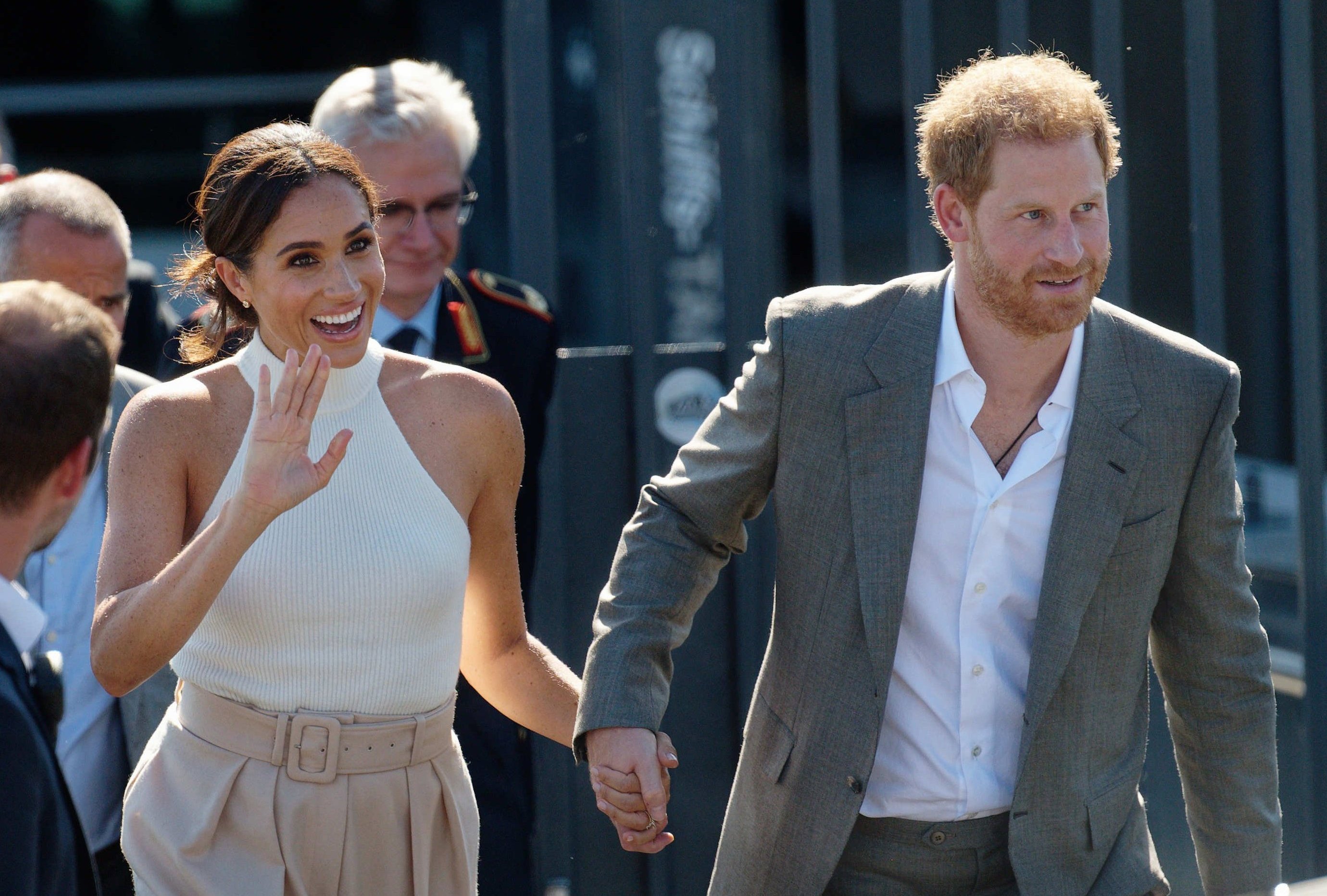 Prince Harry, Duke of Sussex, and his wife Meghan, Duchess of Sussex, walk to a car after taking a boat trip on the Rhine. | Source: Getty Images