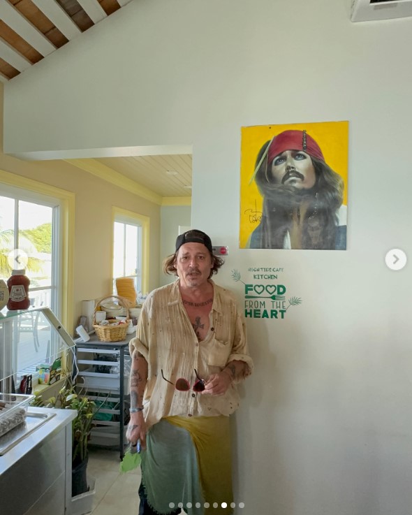 Johnny Depp posing next to his Captain Jack Sparrow artwork at Lorraines Cafe & High Tide in Exuma, Bahamas, on August 30, 3034 | Source: Instagram/killerbartender