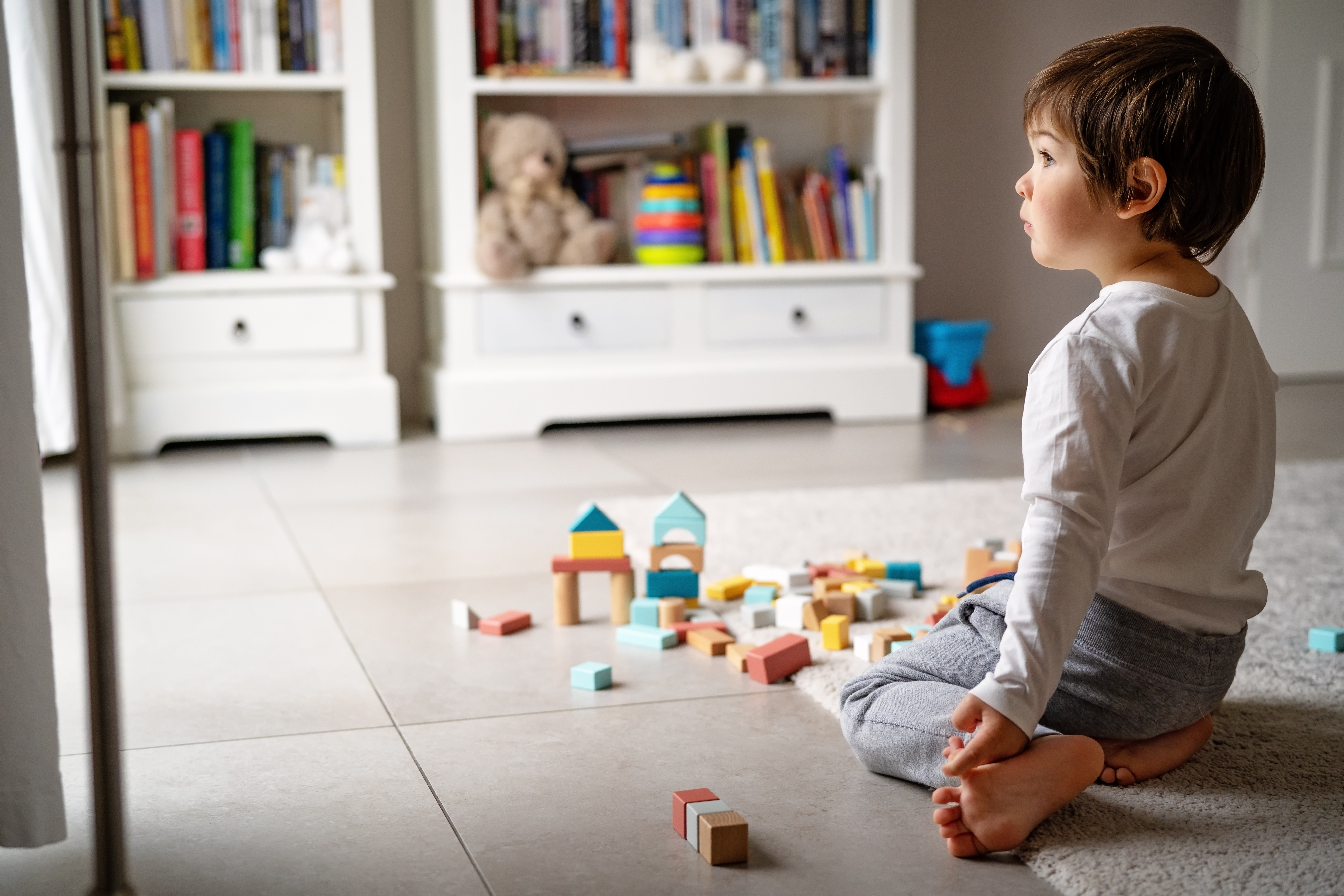 A young boy playing with blocks | Source: Shutterstock