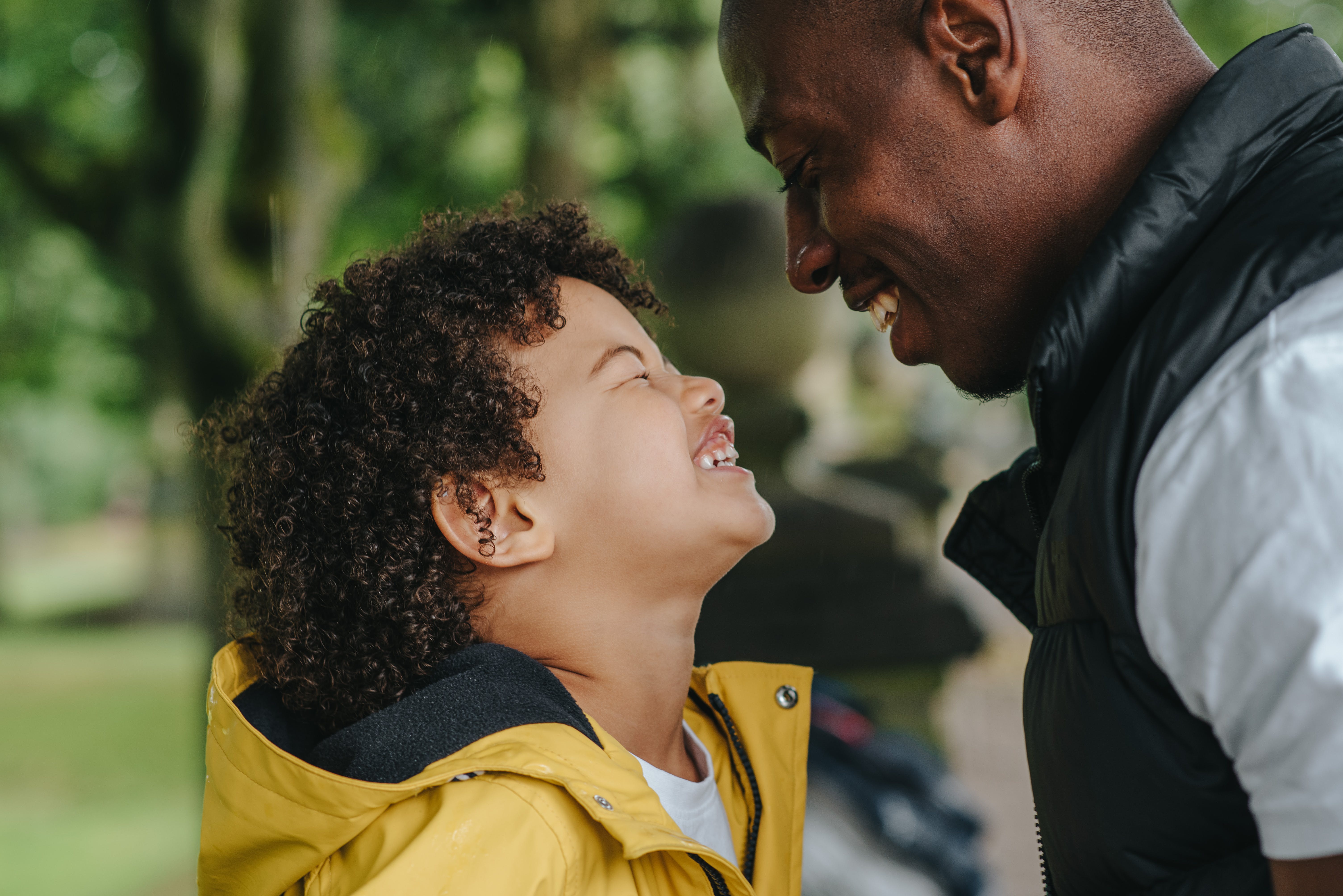 A man and a young boy laughing | Source: Pexels
