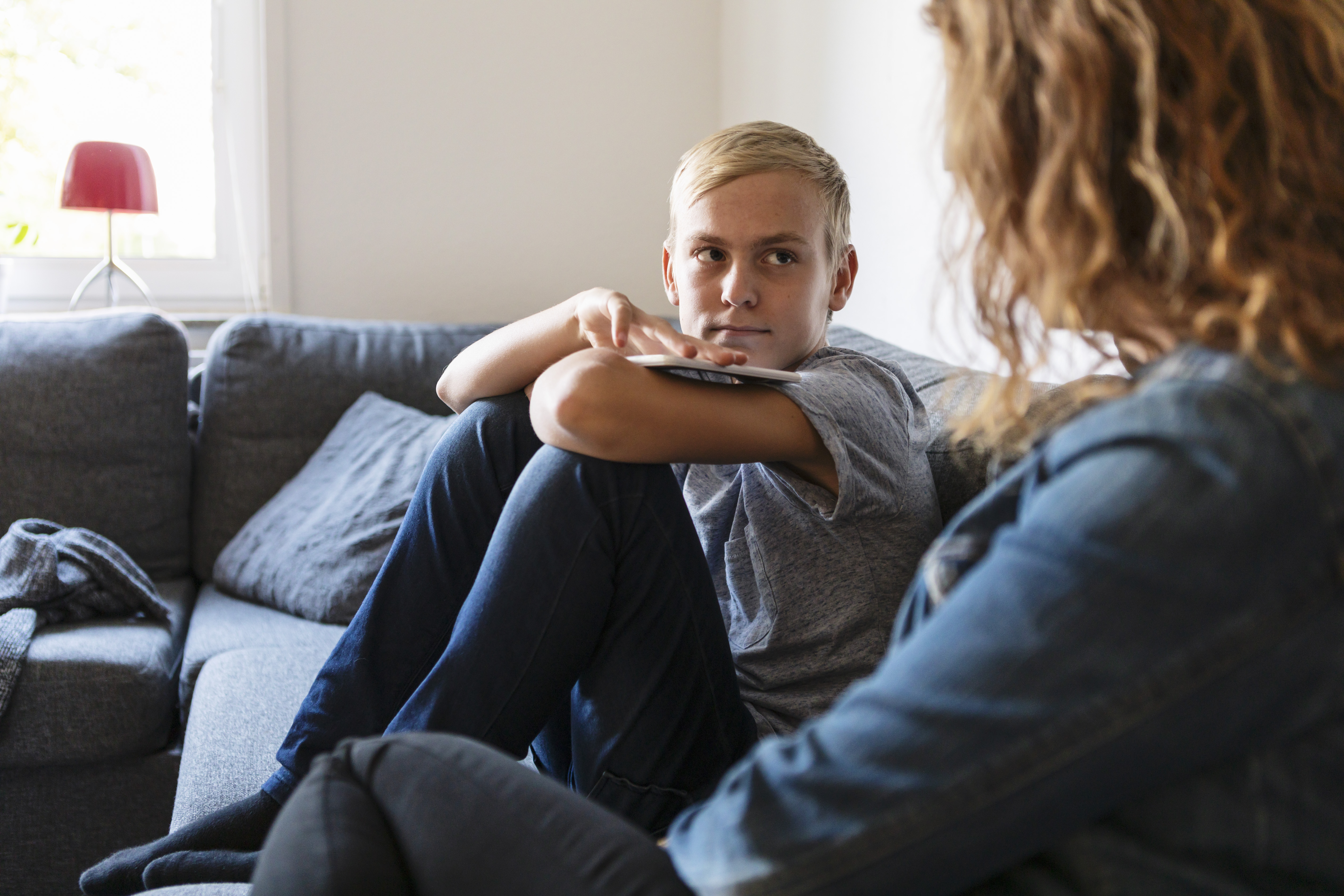 Teen boy having a conversation with his mom | Source: Getty Images