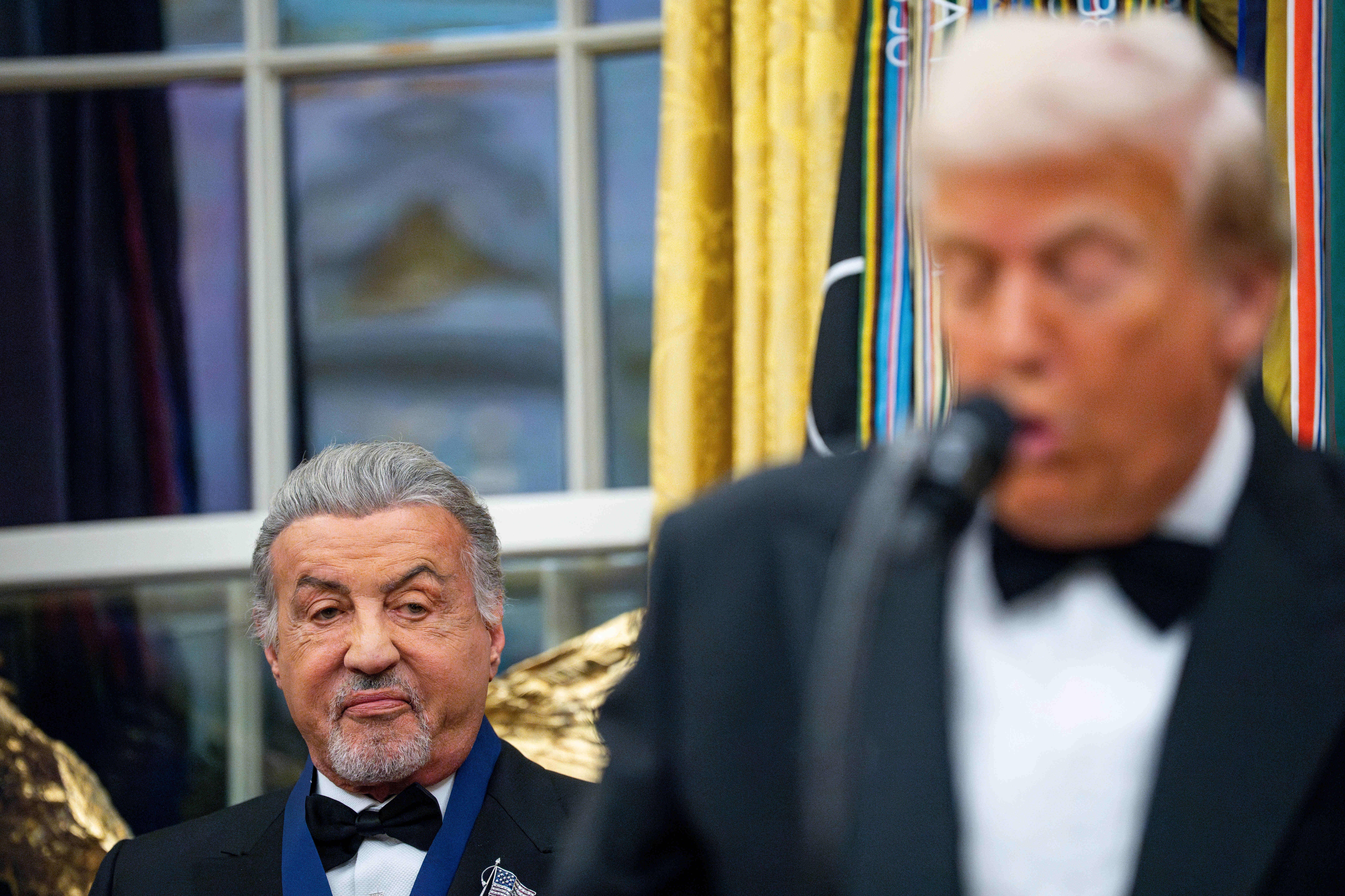 Sylvester Stallone listens as US President Donald Trump speaks during the Kennedy Center Honors ceremony