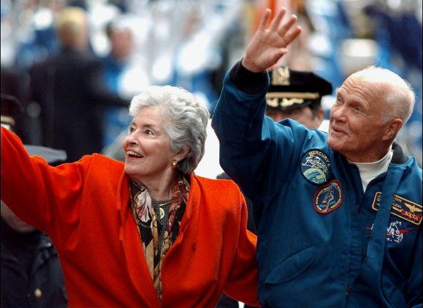 John Glenn and Annie greet crowd from open car in parade up lower Broadway honoring Glenn and crew of the Discovery space shuttle, undated image. | Photo: Getty Images