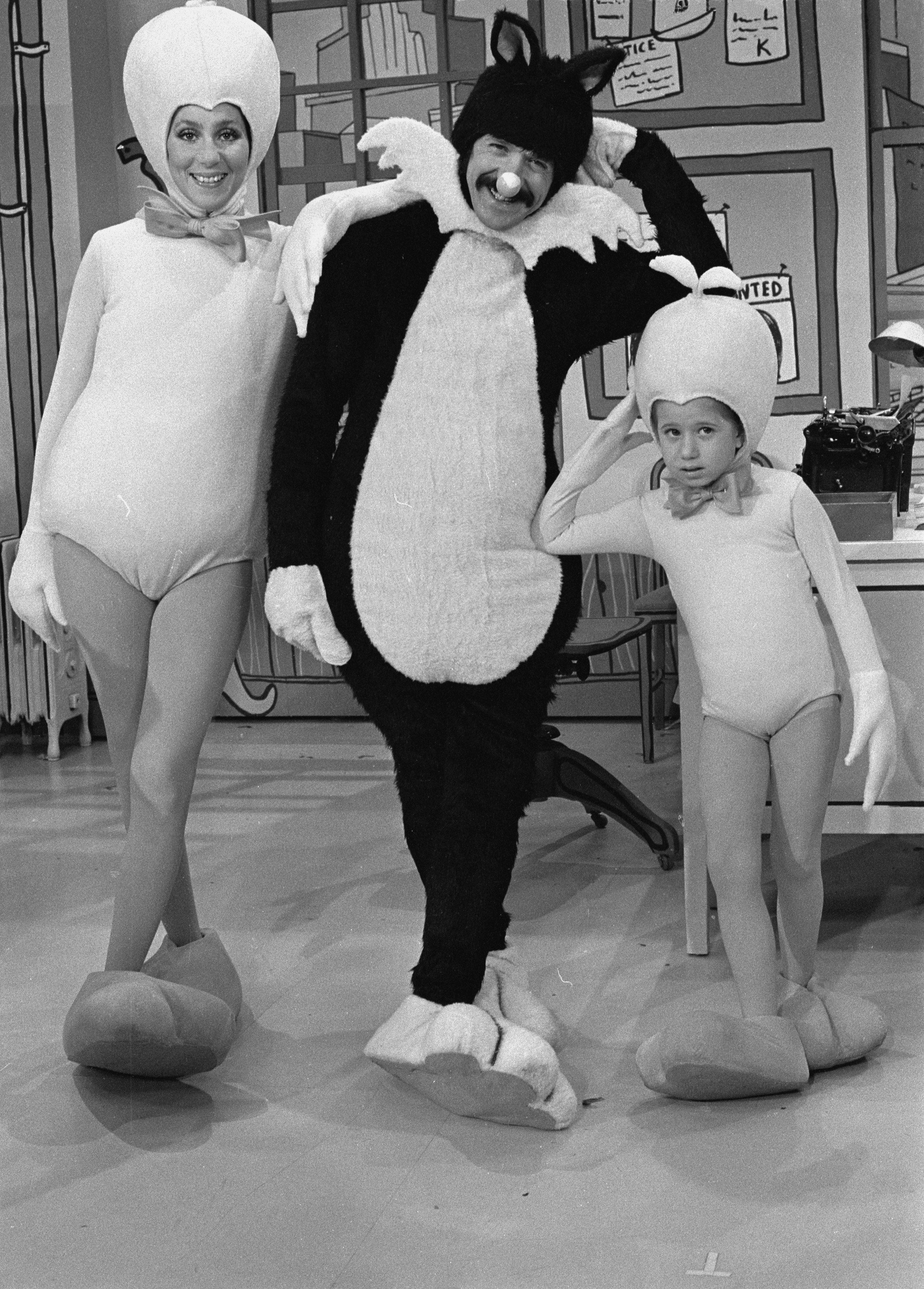Cher and Sonny Bono pose in Tweety Bird and Slyvester costumes along with their son Chaz, also in a Tweety costume, during a skit from the television variety show "The Sonny and Cher Show," February 19, 1976.| Source: Getty Images