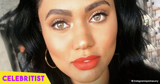 Ayesha Curry rocks bright red lipstick and yellow hoodie in recent picture