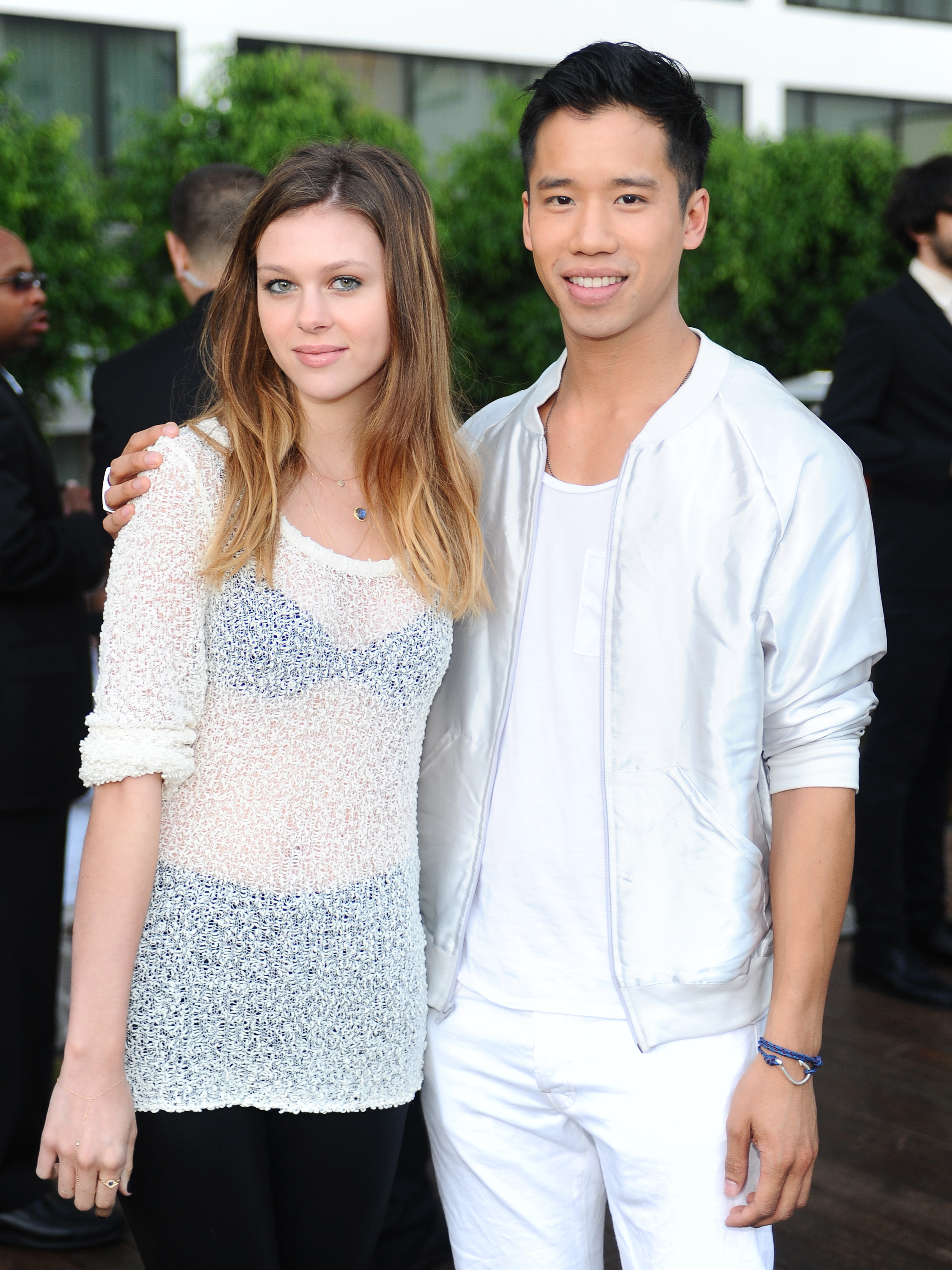 Nicola kept it effortless and flirty for a summer soirée celebrating "The Mindy Project," striking a fun-loving pose with stylist Jared Eng. Her sheer knit top and blue bralette brought off-duty chic to SkyBar at the Mondrian on 25 August 2012, perfectly matched by Eng's all-white look.