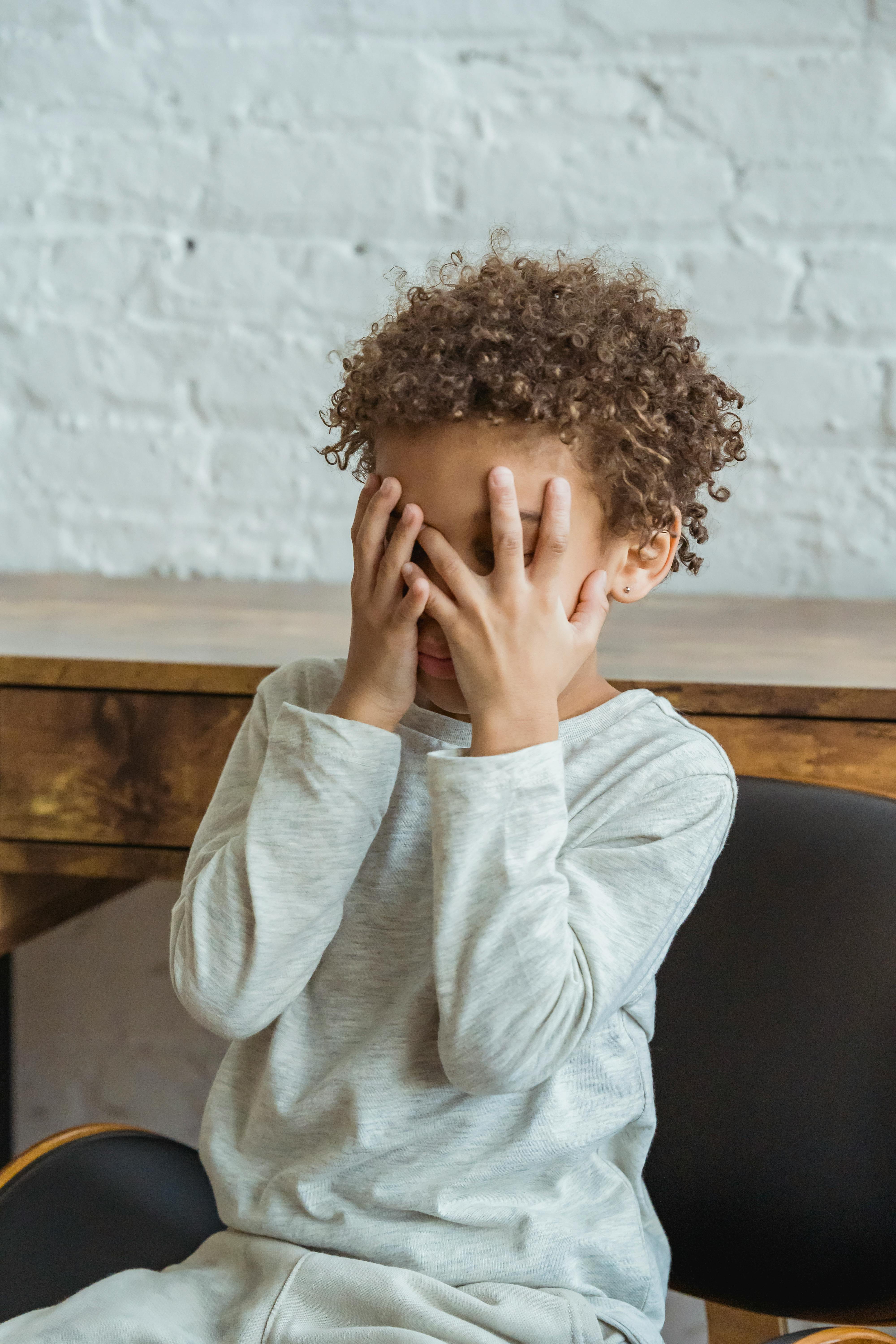 A child covering his face with his palms | Source: Pexels