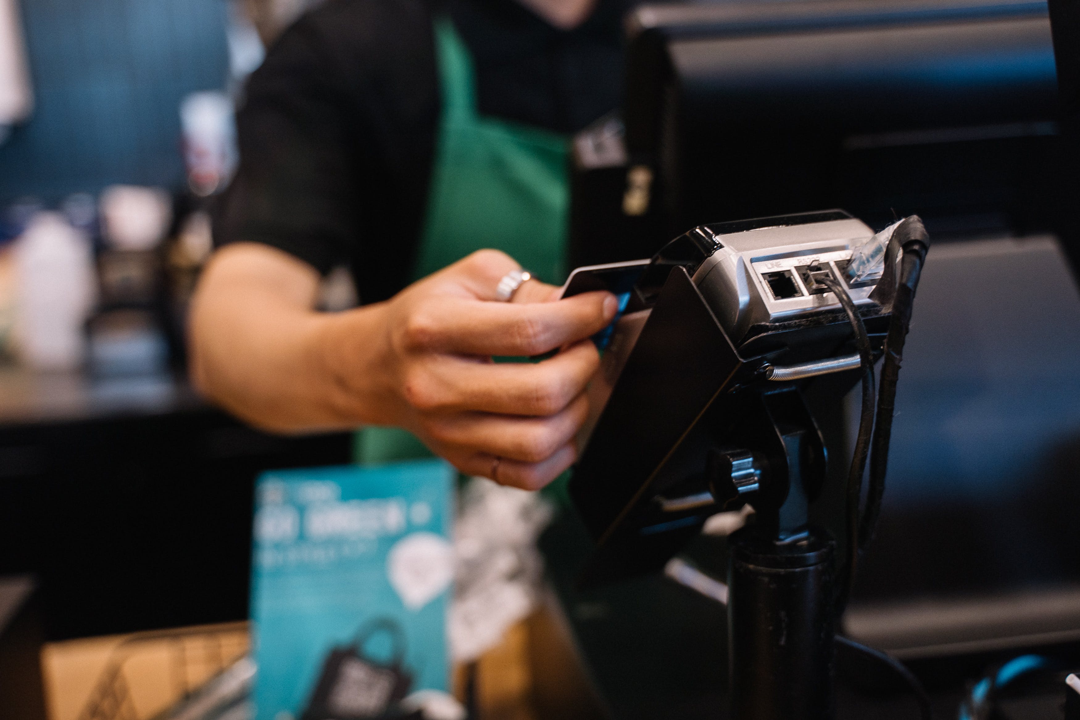 A barista inserting a card into a payment terminal | Source: Pexels