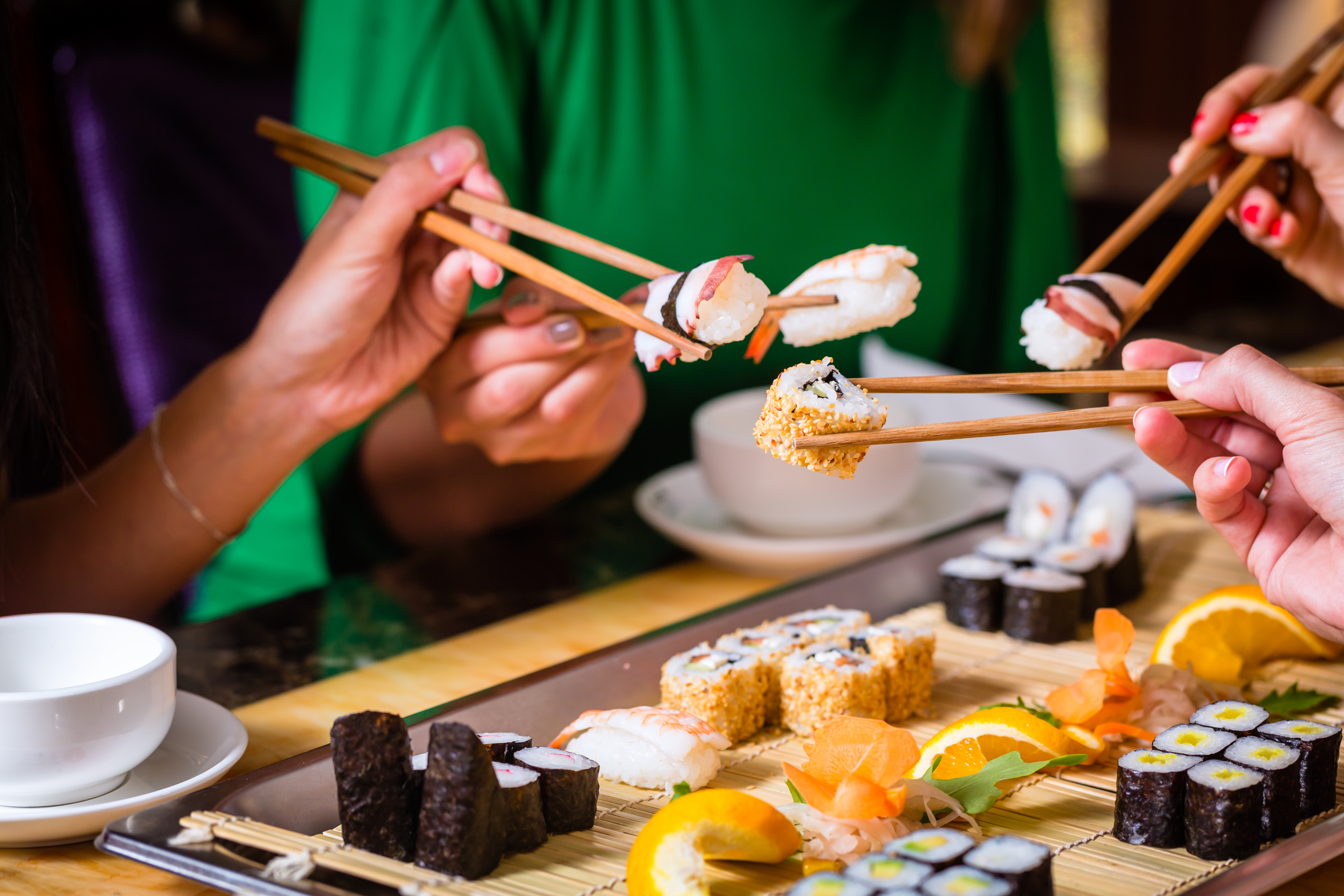 People eating sushi | Source: Shutterstock