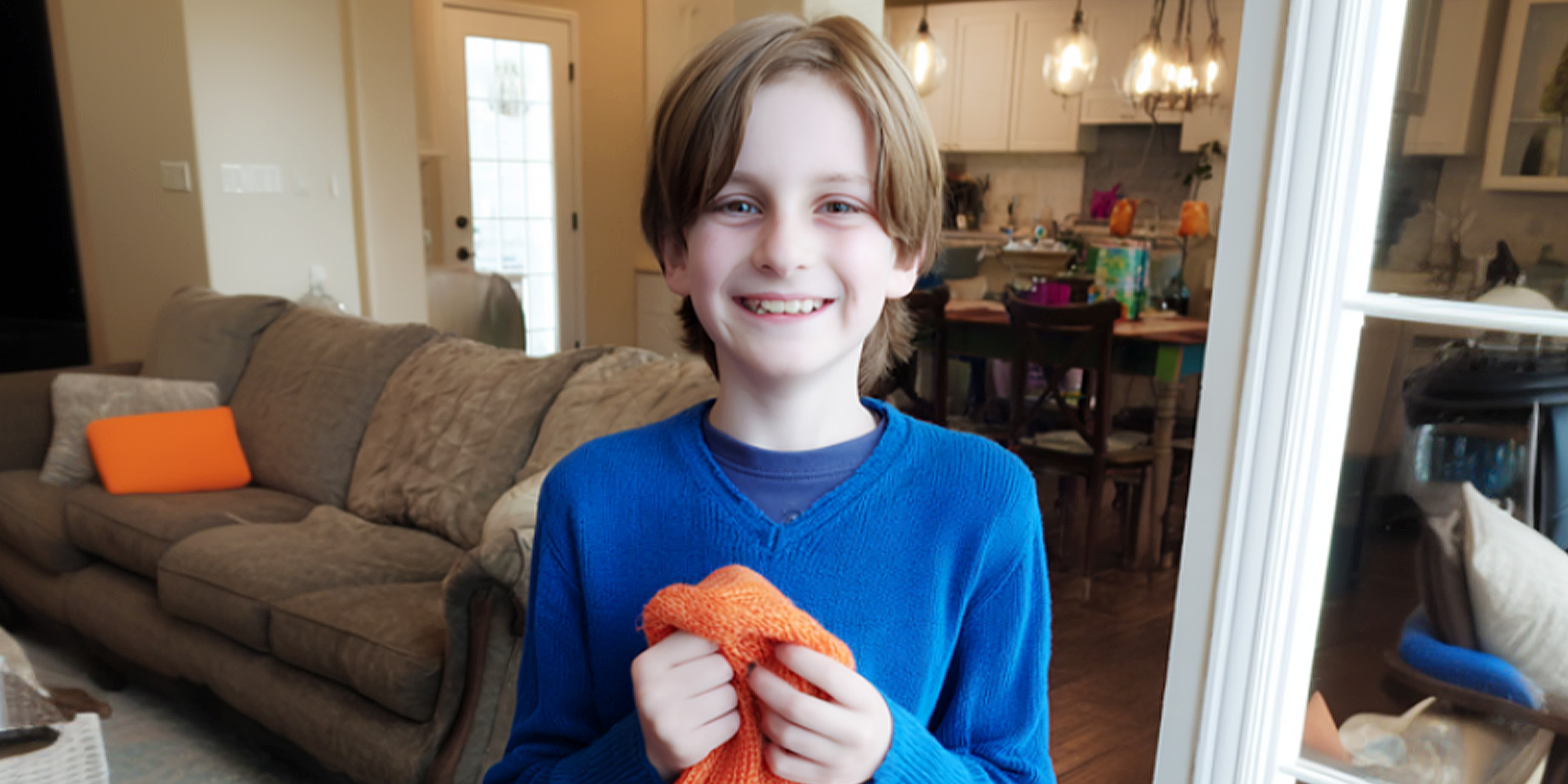 A boy holding a scarf | Source: AmoMama