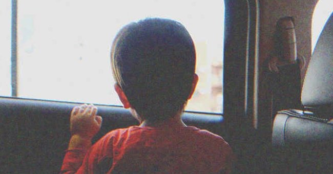 A little boy looking out a window | Source: Shutterstock