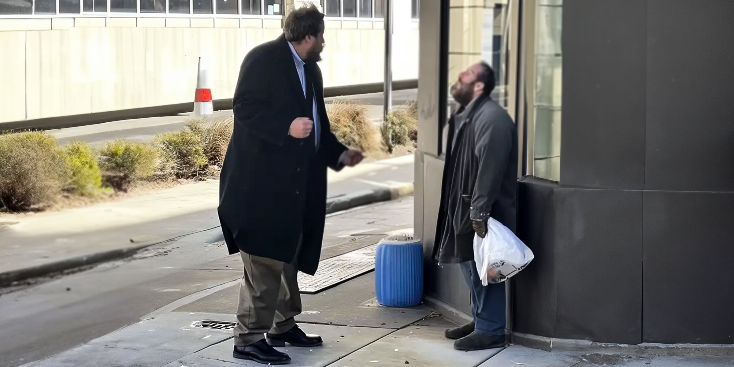 A man in a suit berating a homeless man | Source: Amomama