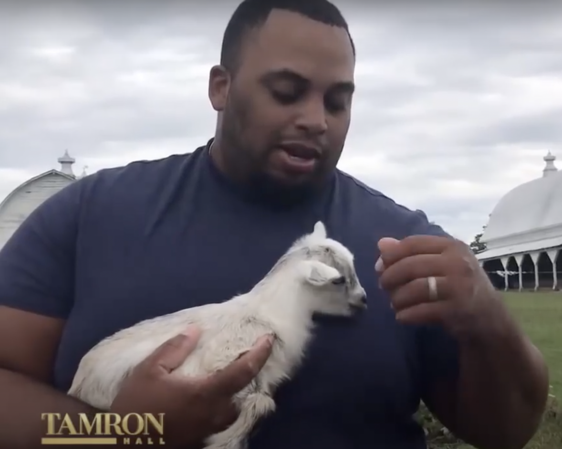 The athlete photographed while holding a baby goat | Source: YouTube/TamronHallShow