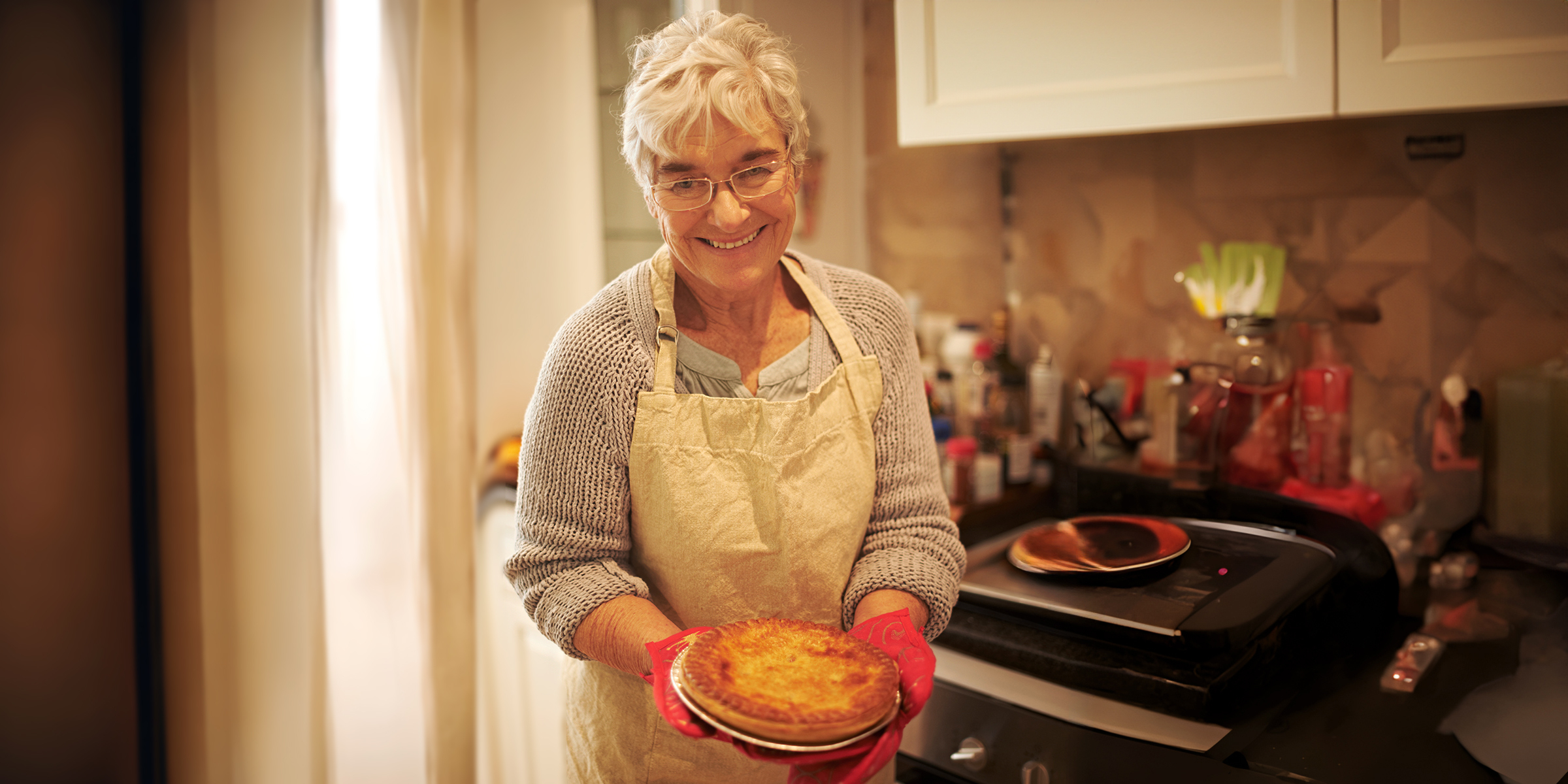 A happy woman holding a pie | Source: Shutterstock