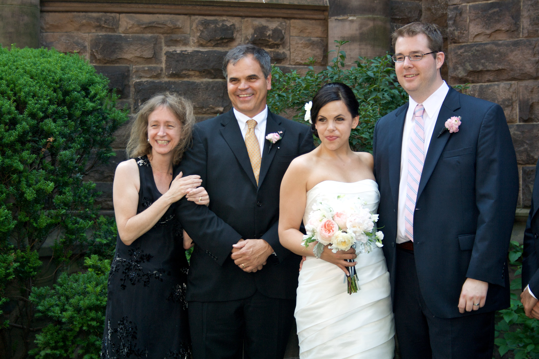 A bride and groom with an older couple | Source: flickr.com/mattymatt