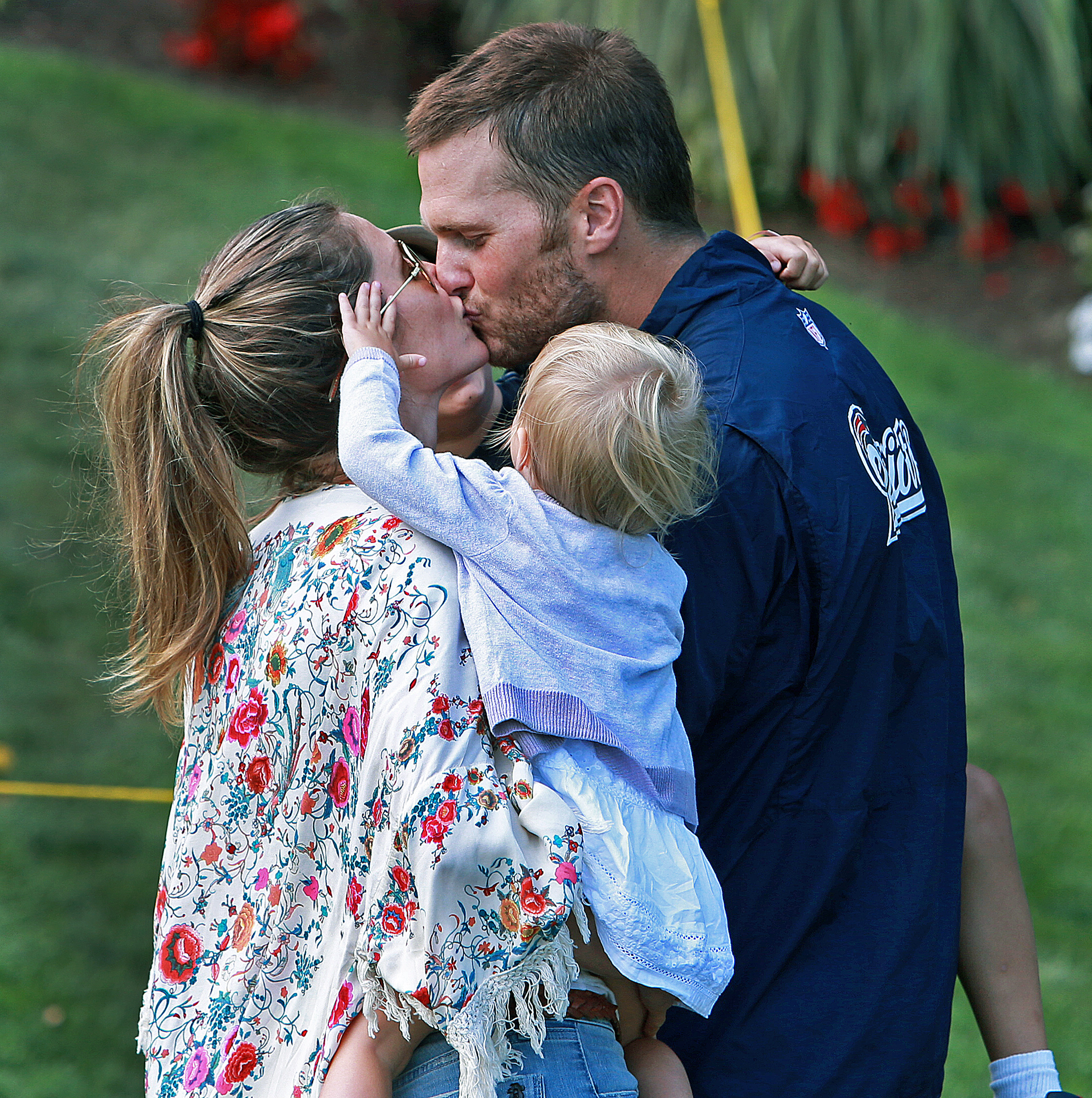 Tom Brady, Gisele Bundchen and their daughter at the fields of Gillette Stadium on August 11, 2014 | Source: Getty Images