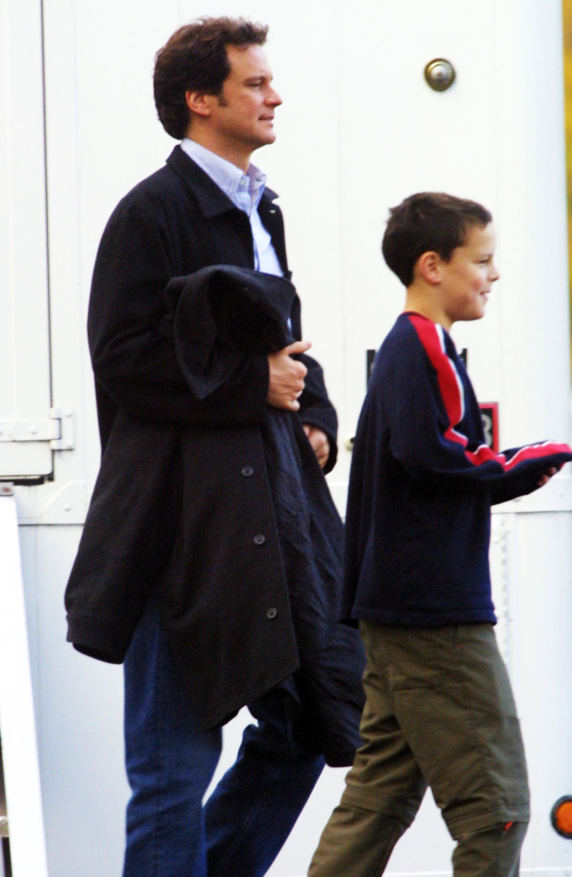 Colin Firth and his son Will Firth leave their trailer on the set of his film "New Cardiff" on November 26, 2001, in Vancouver, British Columbia. | Source: Getty Images