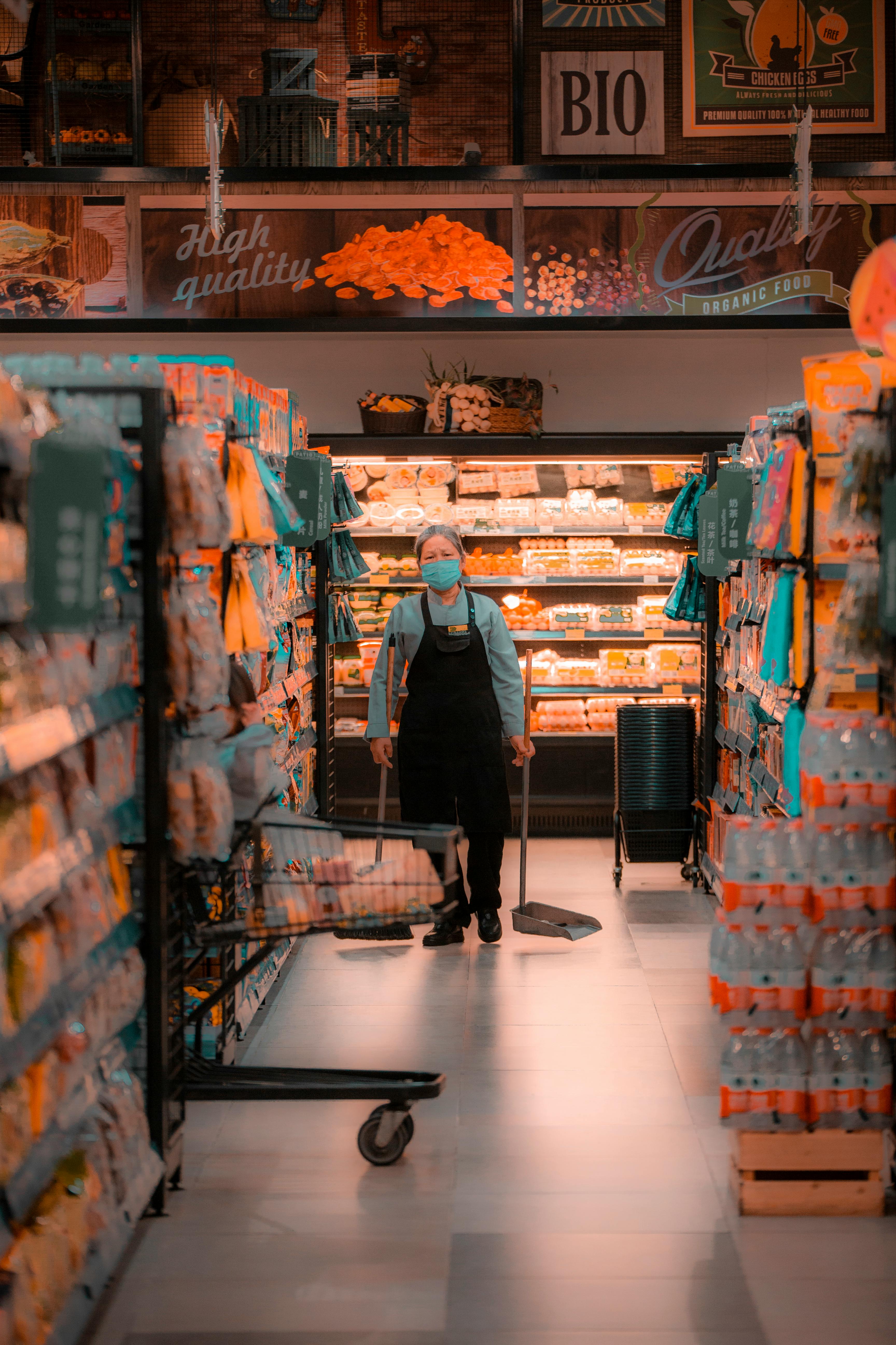 A cleaning lady in a supermarket aisle | Source: Pexels