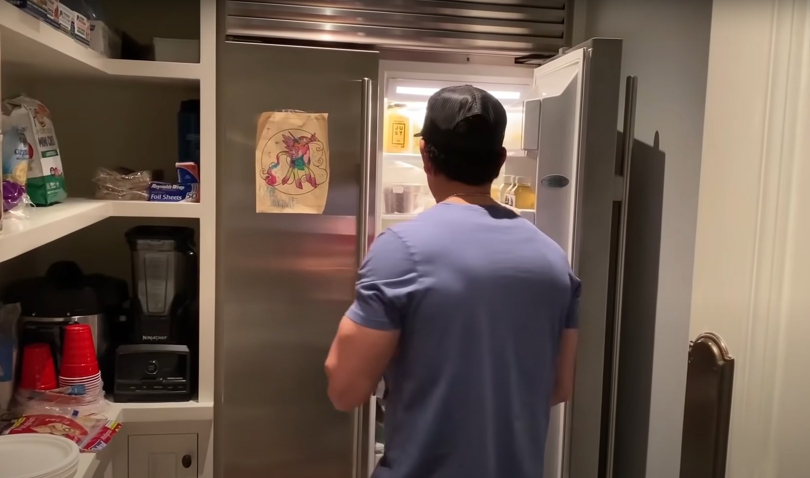Pictured: Mark Wahlberg showing off what he keeps in his fridge under a healthy diet on Men's Health "Gym & Fridge" | YouTube/@MensHealth