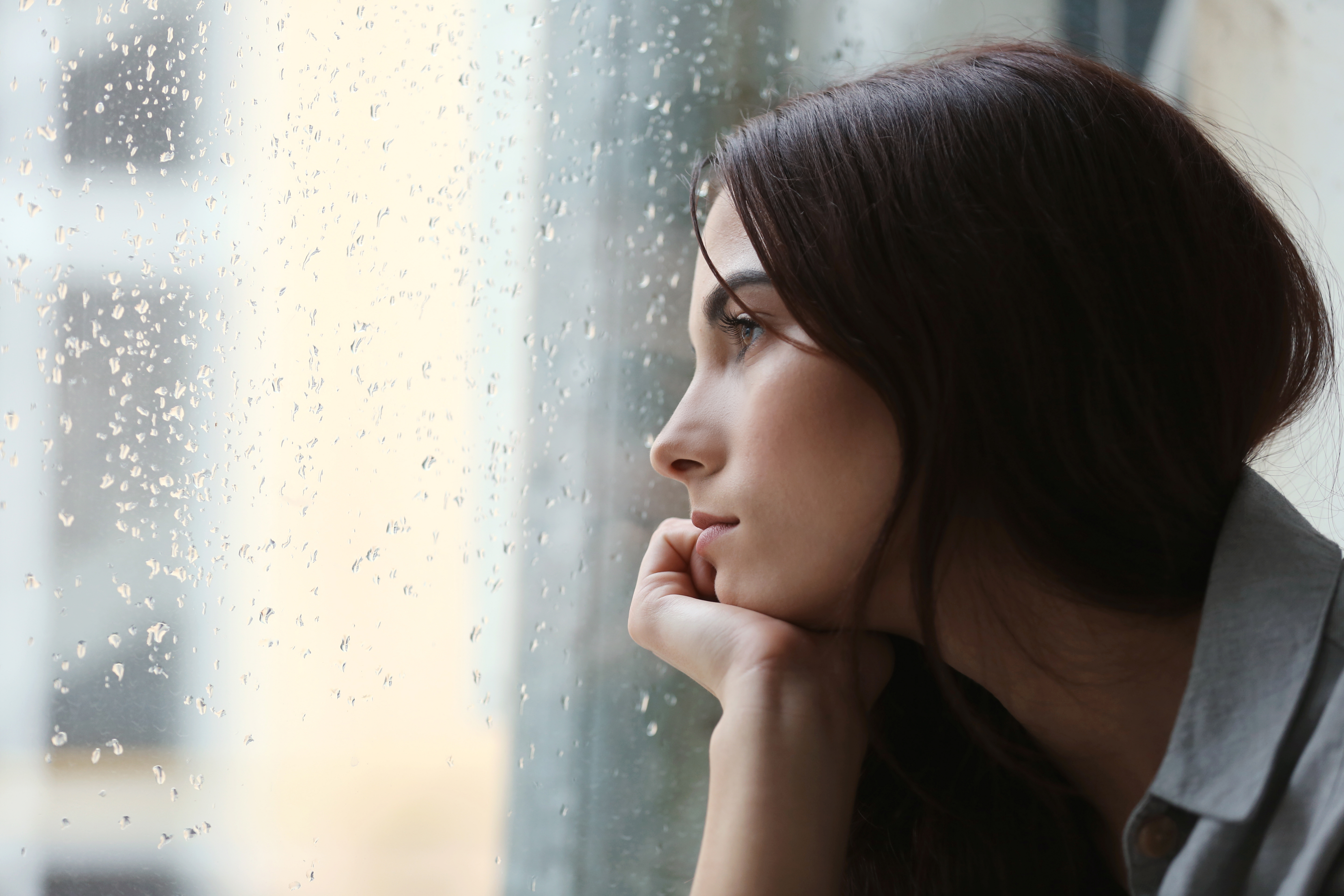 A woman looking out a window | Source: Shutterstock