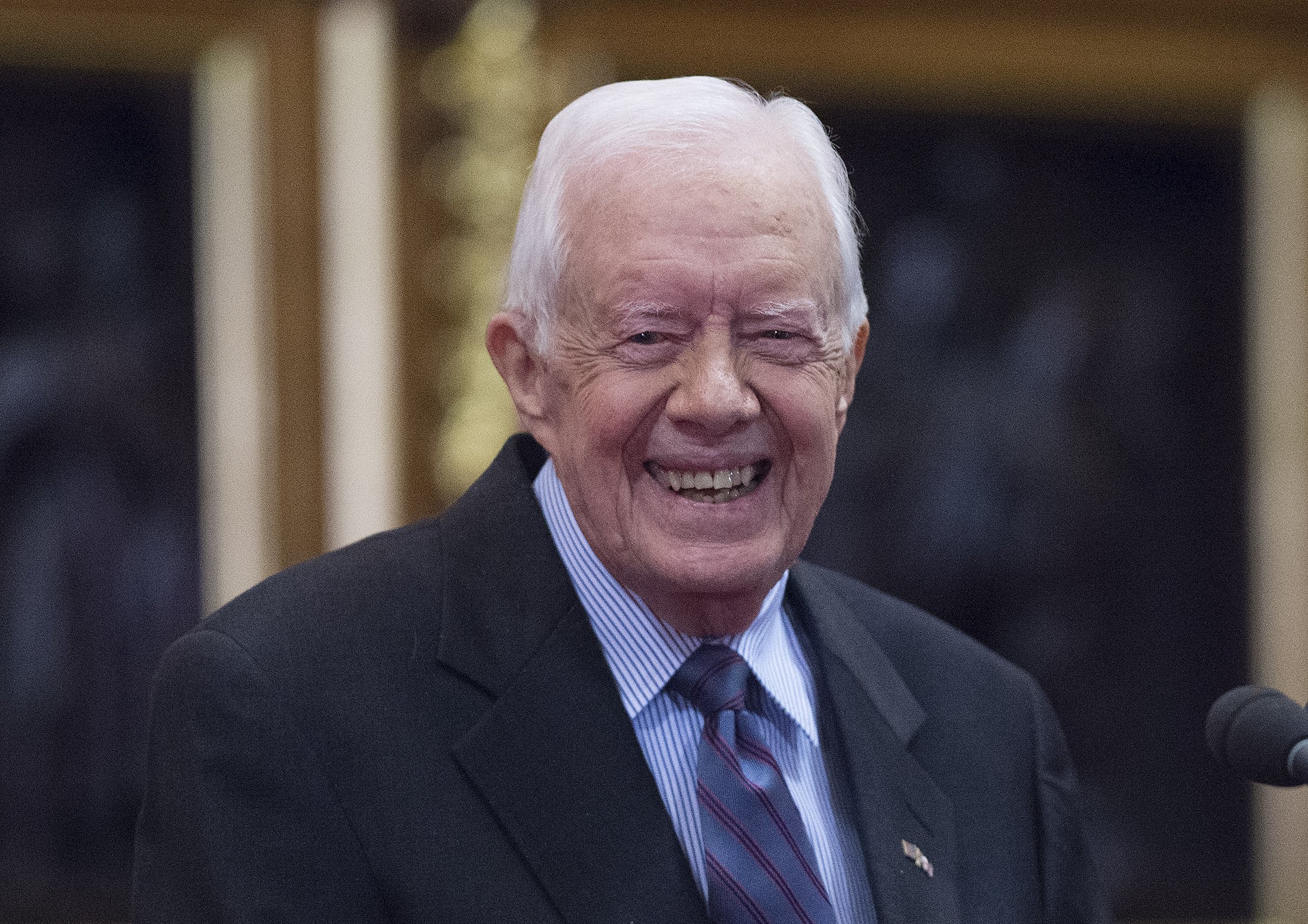 Former U.S. President Jimmy Carter receives delivers a lecture on the eradication of the Guinea worm, at the House of Lords on February 3, 2016, in London. | Source: Getty Images.