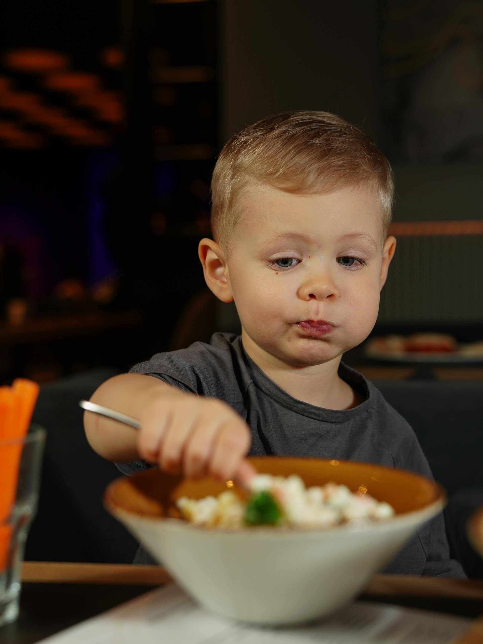 A child eating food in a restaurant | Source: Pexels