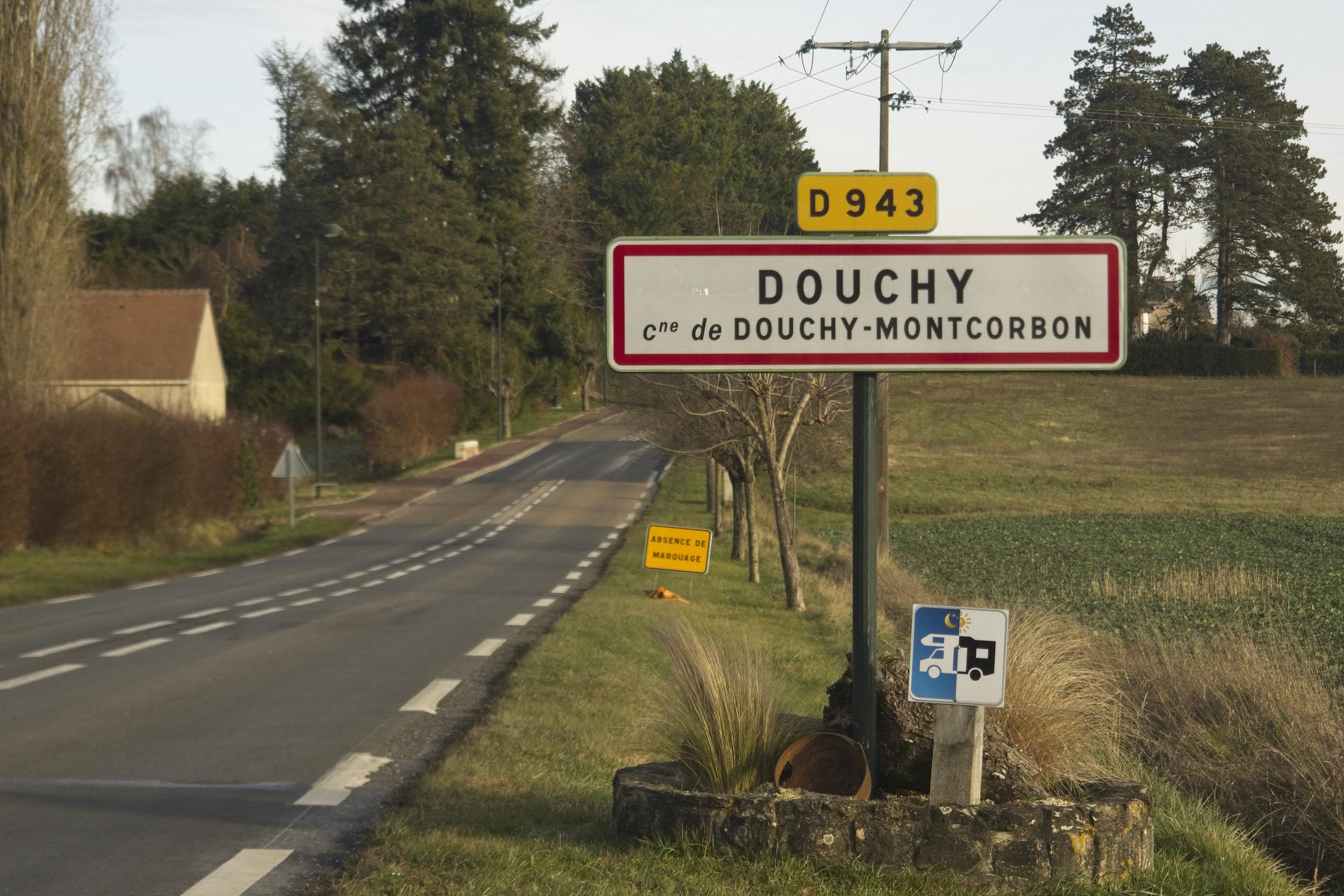 This photograph taken on January 16, 2024, shows the town entrance panel of the village Douchy, where is located the residence of Alain Delon named La Brulerie, central France. | Source: Getty Images