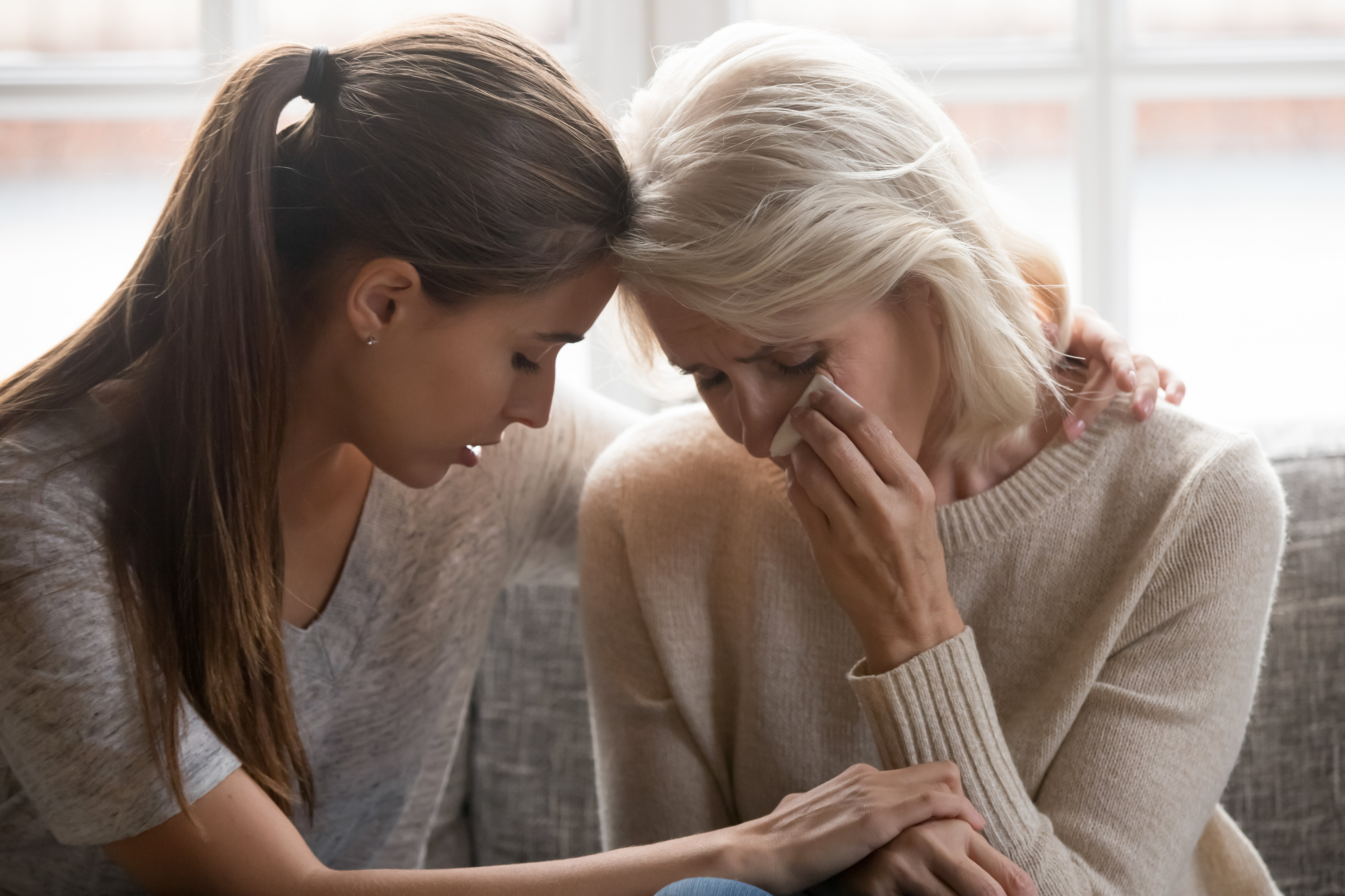 Grown-up daughter feeling sorry for her mother | Source: Shutterstock
