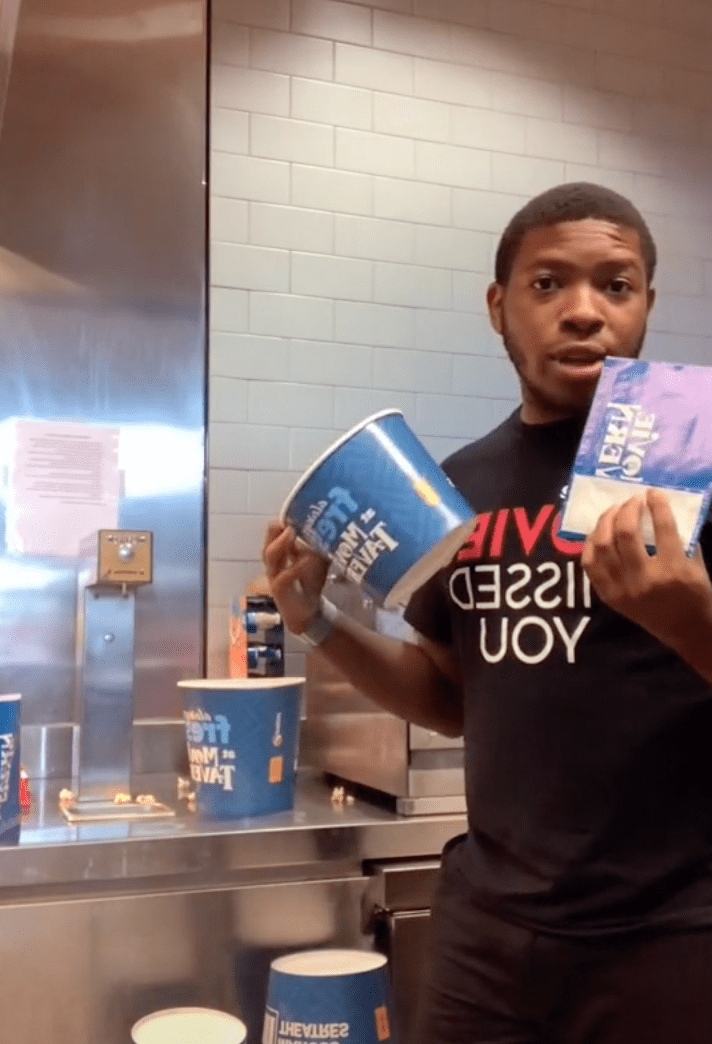 In a viral video a man acts like a cinema worker to demonstrate how employees scam customers with popcorn bucket sizes | Photo: TikTok/thatcoolguy.25597