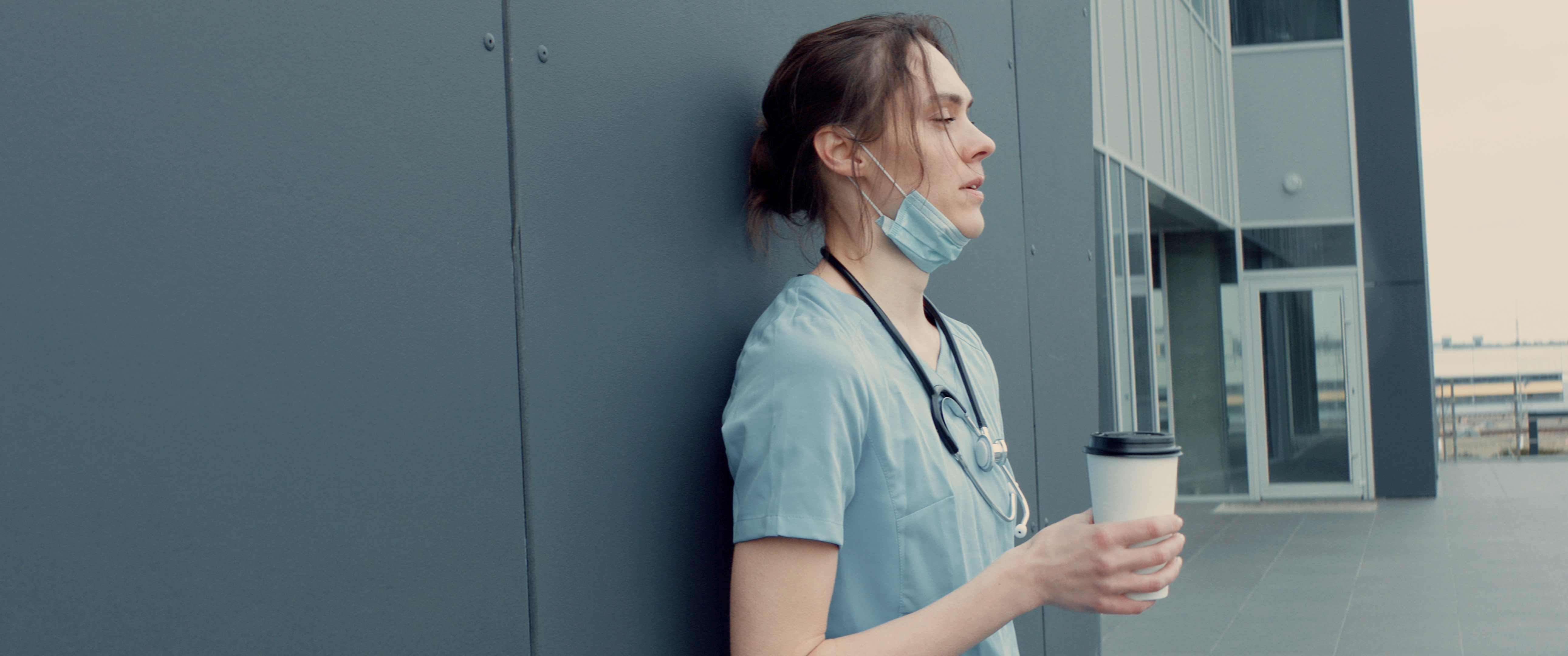 A tired nurse outside taking break | Source: Shutterstock