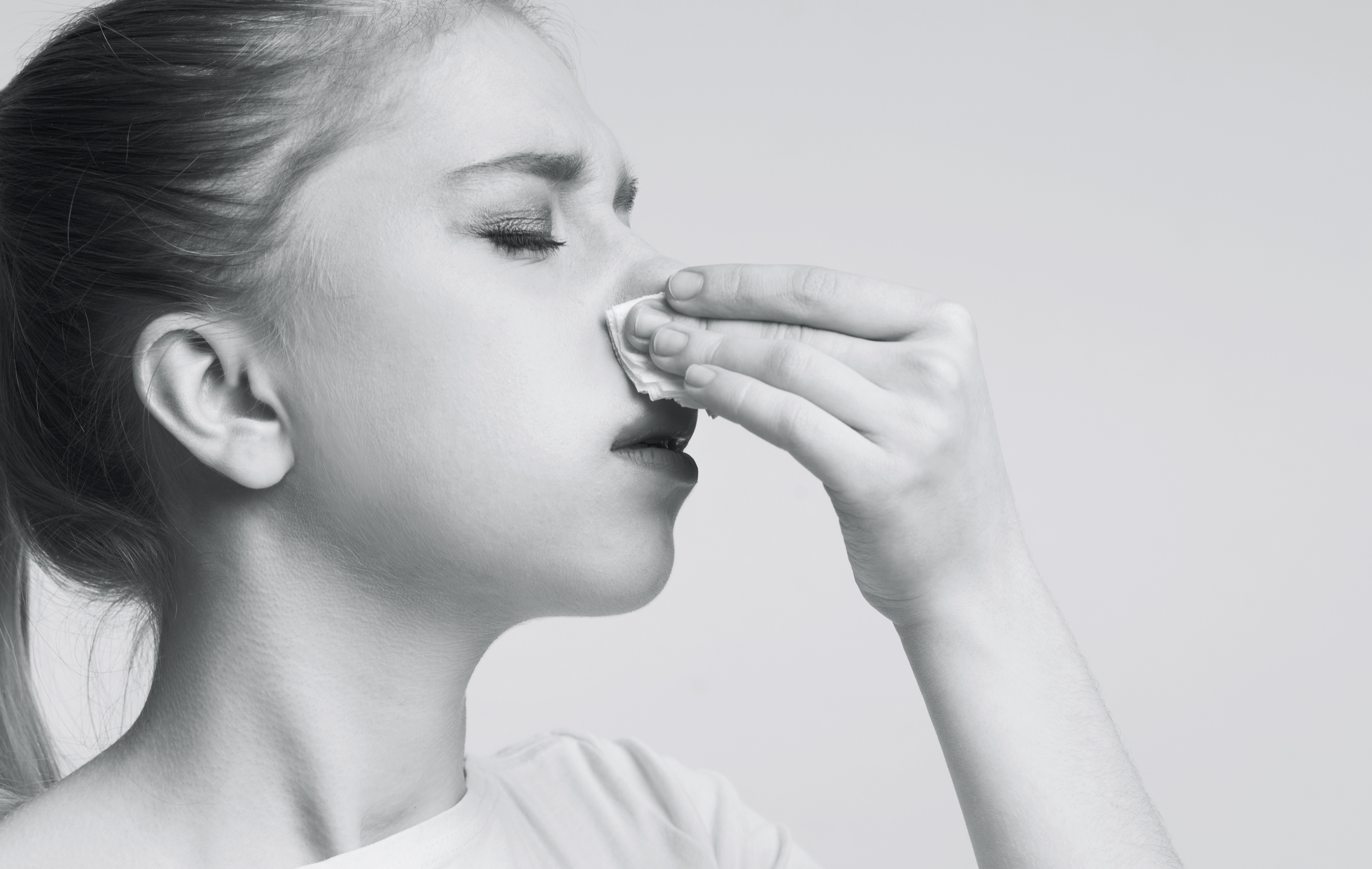 A young woman suffering from a nosebleed | Source: Getty Images