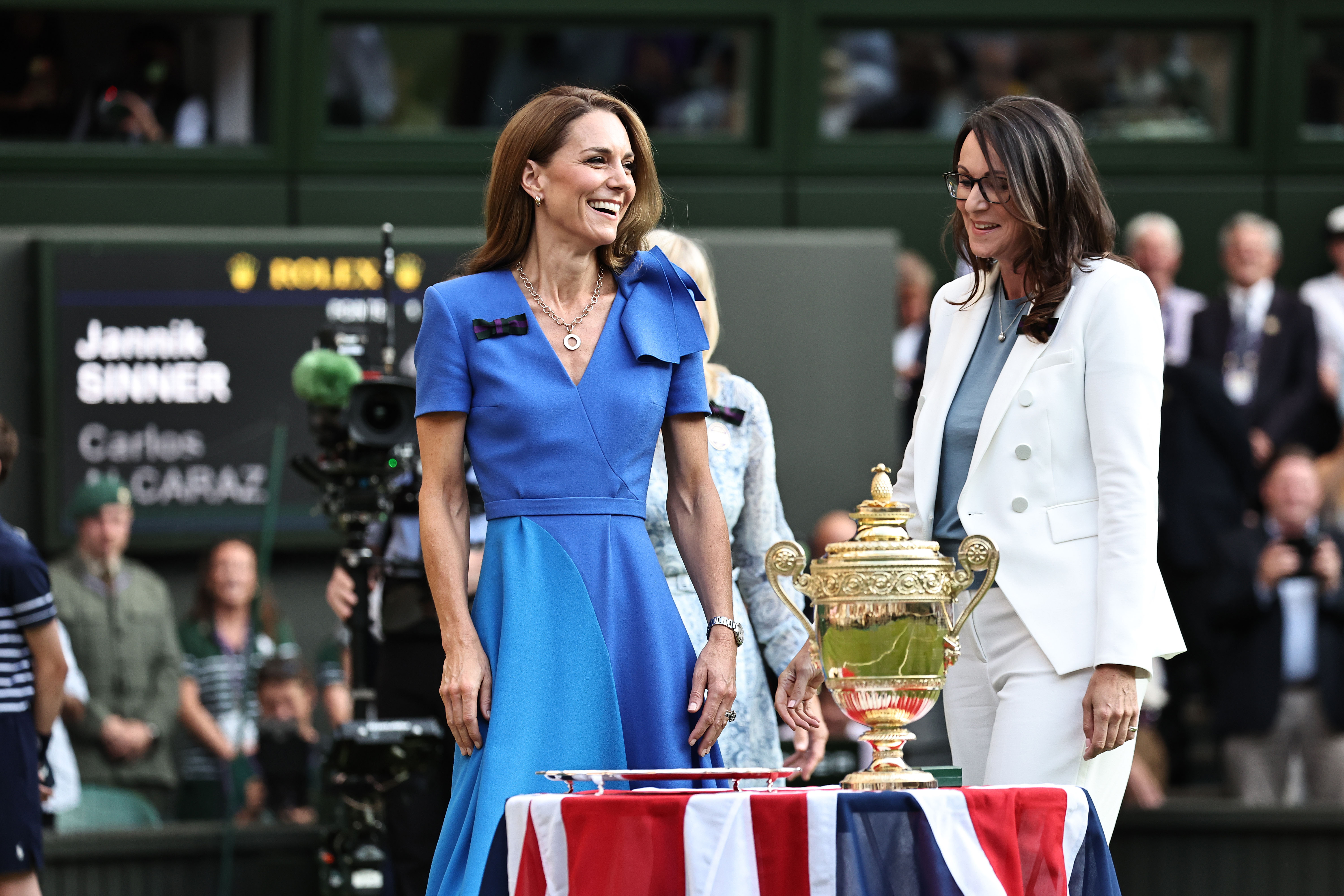 Princess Catherine smiles while standing beside the Wimbledon trophy table during the award ceremony.