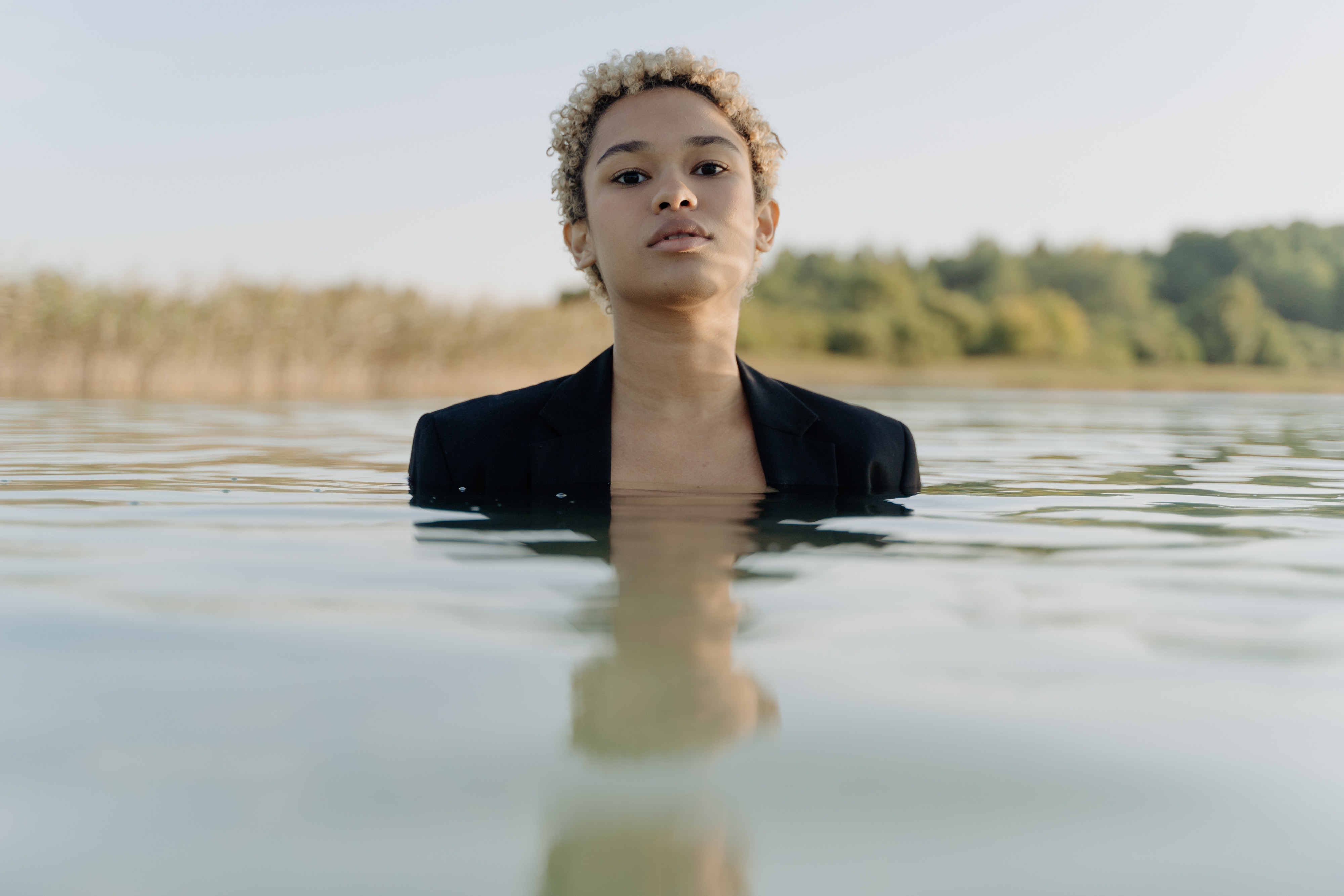 A woman standing in water.  | Source: Pexels
