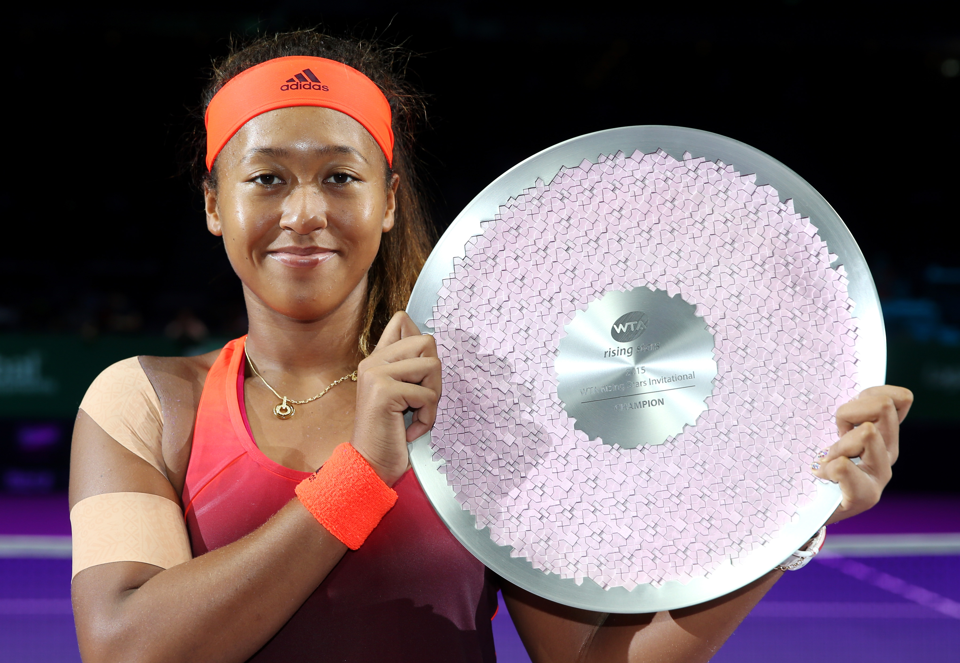 Naomi Osaka posing with her trophy after defeating Caroline Garcia of France during the WTA Rising Stars Final in Singapore on October 25, 2015. | Source: Getty Images